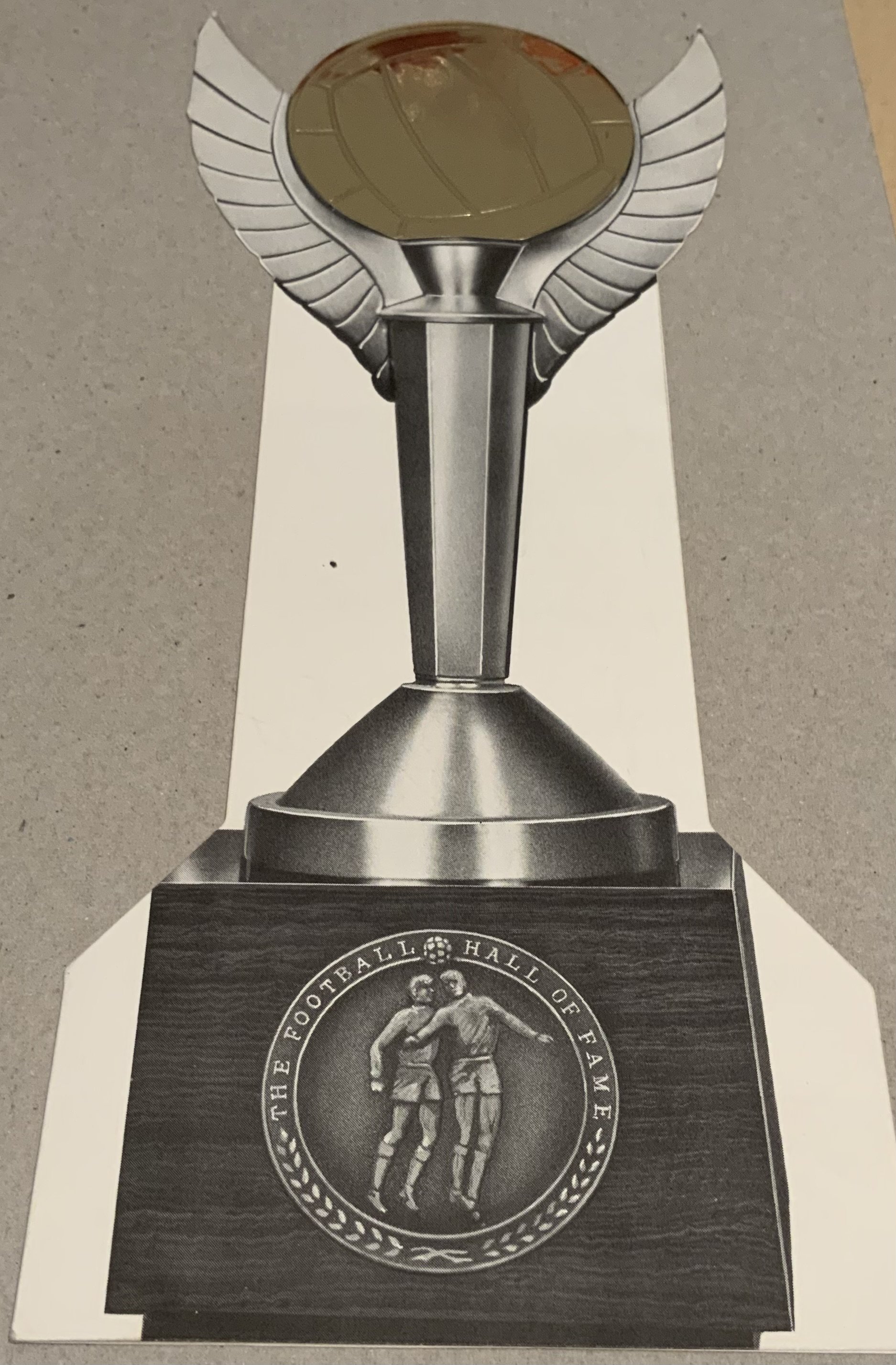 Hall of Fame Signed Football Dinner Menu: 2002 menu in the shape of the trophy from the first Hall of Fame awards presentation. Alf Ramsey Matt Busby Stanley Rous Bobby Charlton Tom Finney and Tommy Trinder are among the signatories. Over twenty signatures. Good condition.