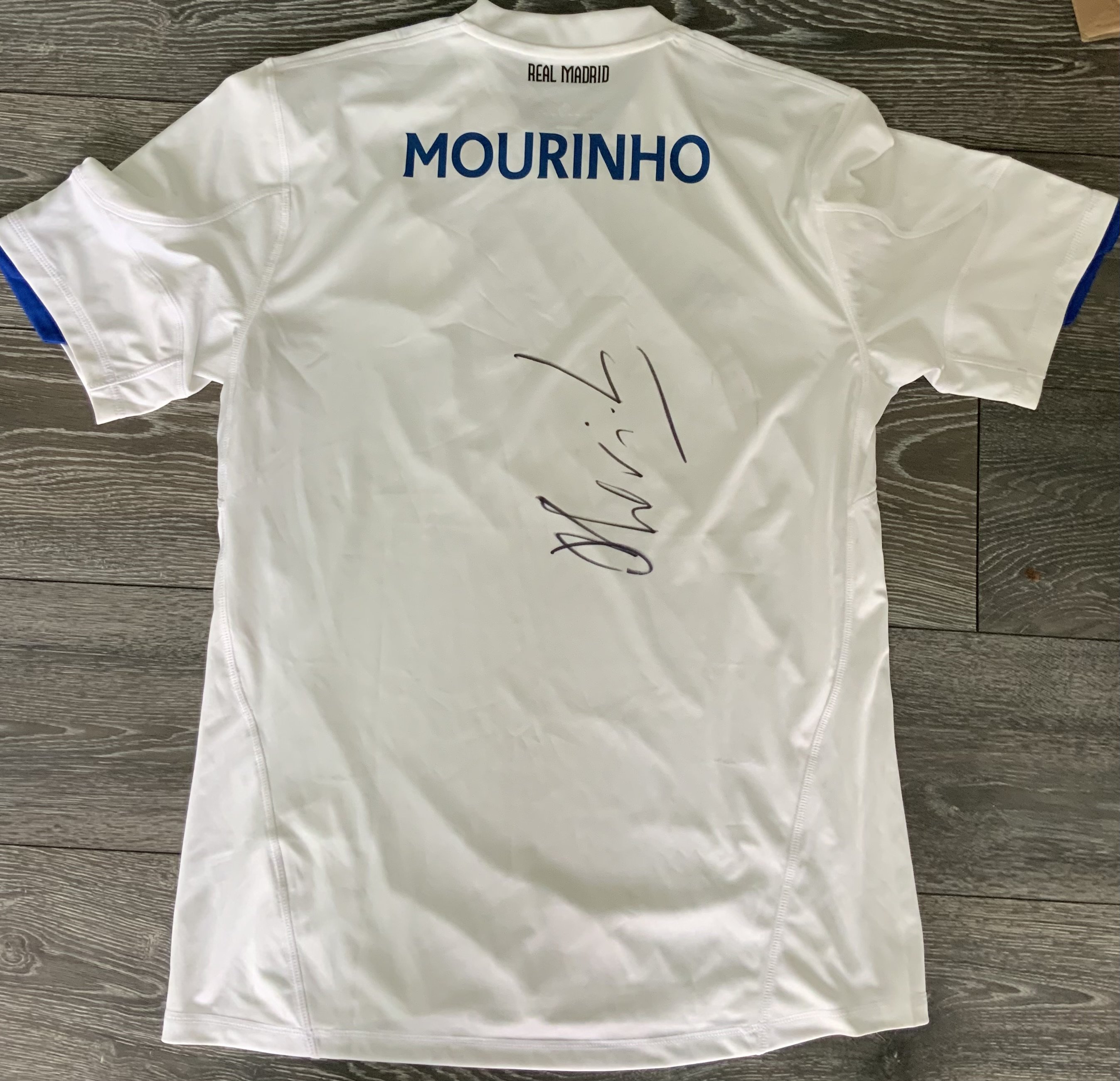 Mourinho Real Madrid 2010 - 2011 Signed Football Shirt: White large home shirt with Mourinho name to rear where he has hand signed clearly without dedication in his first season at the club. From reputable source.