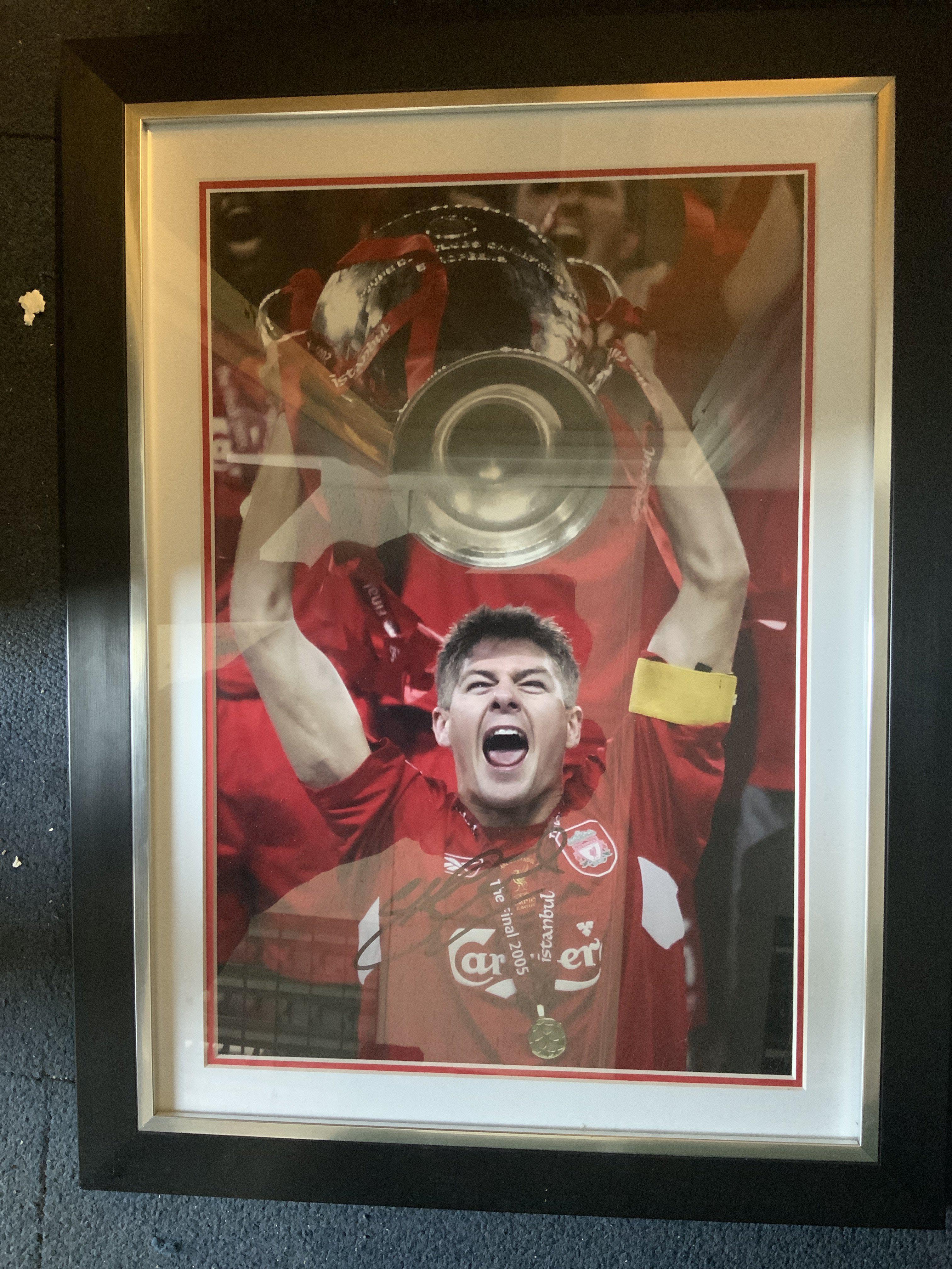 Steve Gerrard Signed Framed Football Photo + More: Depicts Gerrard lifting the 2005 Champions League trophy. Hand signed with COA. Measures 23 x 17 inches. C/W 22 large photos/prints signed by Smith Gerrard Whelan Barnes and more.