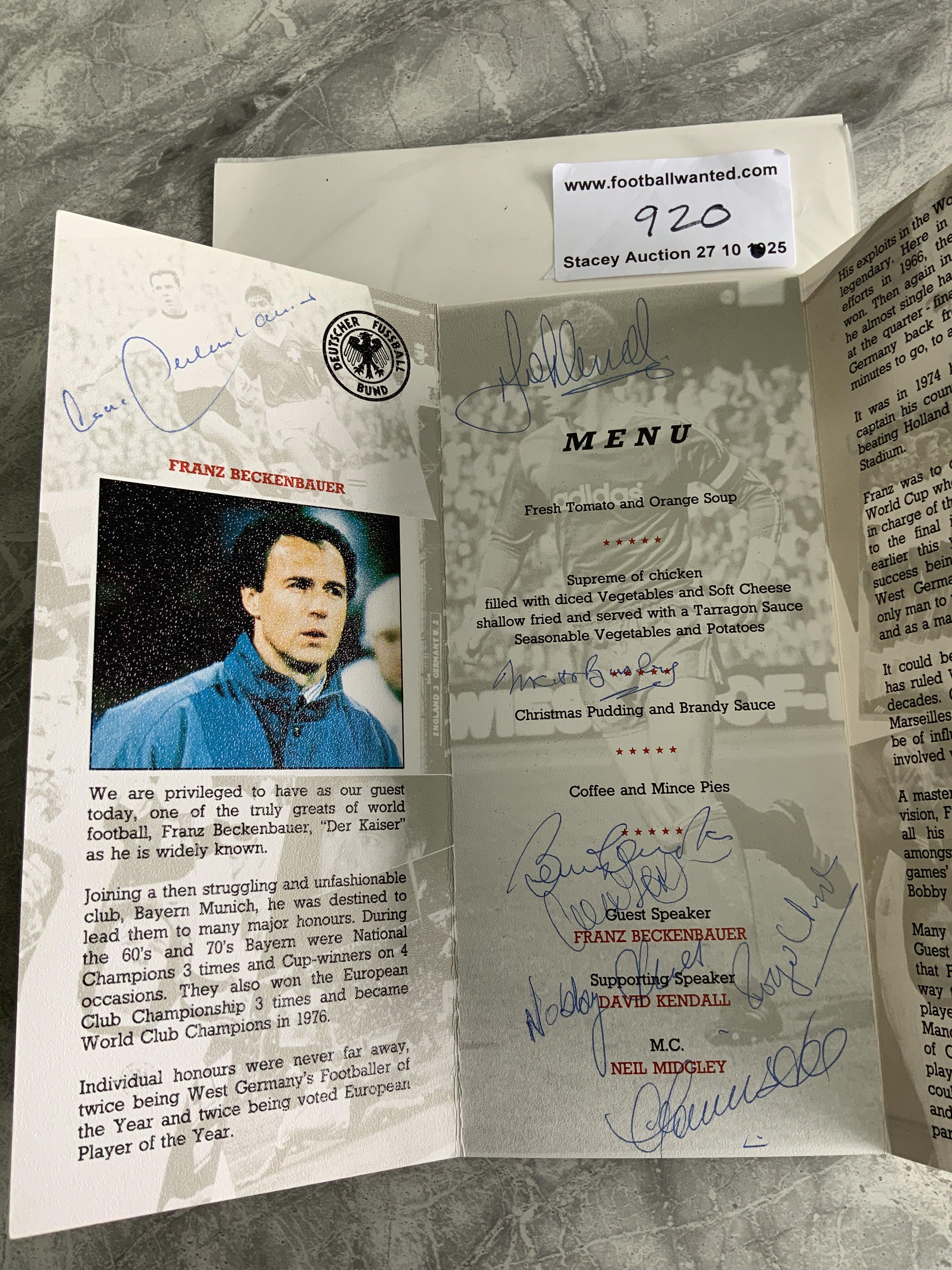 1970 England Players + Beckenbauer Signed Football Menu: Bobby Charlton Enterprises present Franz Beckenbauer menu in Manchester 1990. Signed by Beckenbauer Busby Hunt Stiles Charlton Lee and probably Stepney. Good menu signed by the 1970 England players and Manchester United friends of Bobby Charlton.
