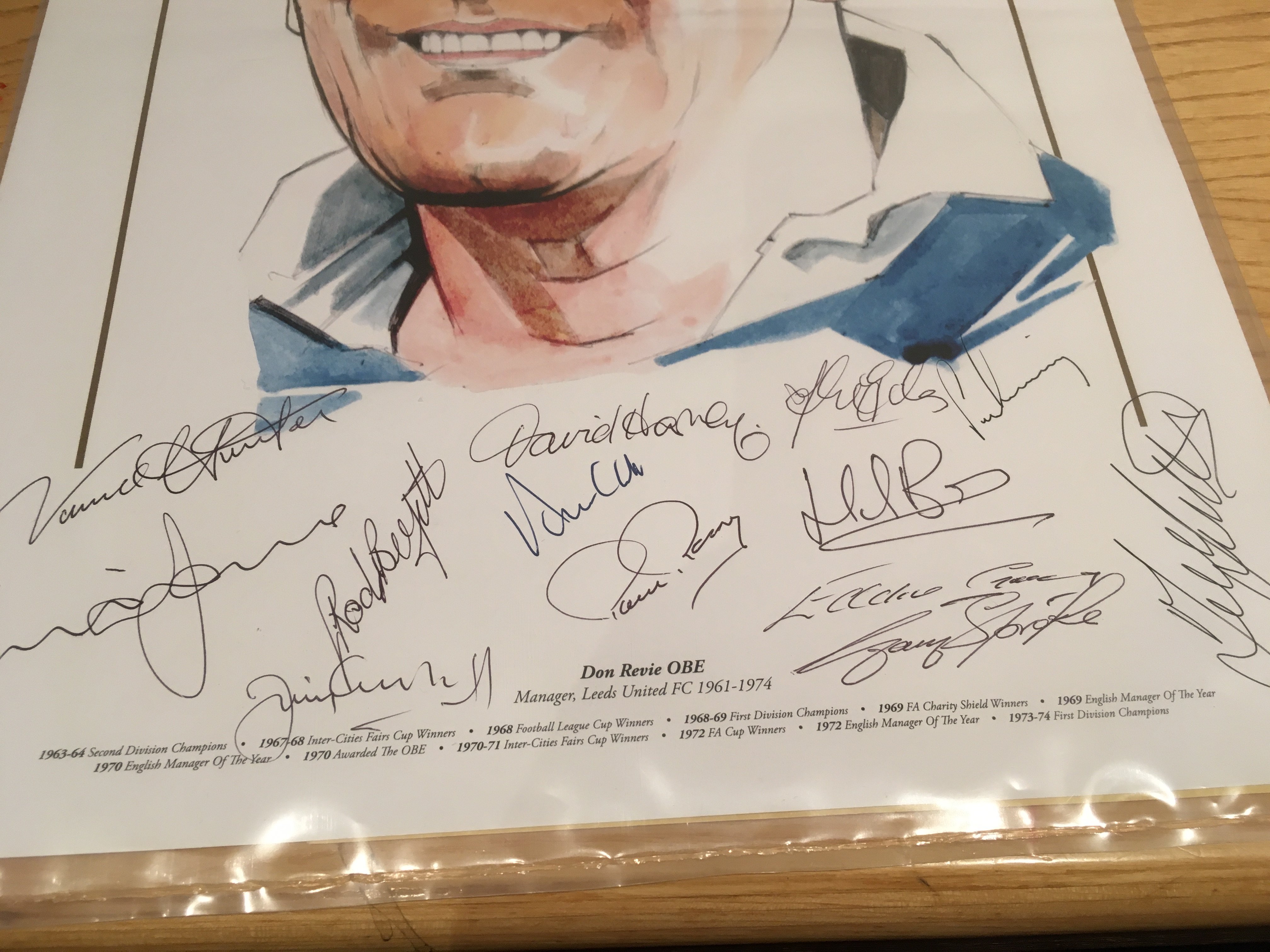 Don Revie Leeds United 1970s Squad Signed Football Print: Stunning 42 x 32cm print of Don Revie with his achievements printed to lower border. Hand signed by his successful players in the 70s. Autographs include Harvey Reaney Gray Hunter Lorimer Clarke Bates Yorath Jones Giles Sprake Belfitt and Greenhoff. Coa from reputable source.