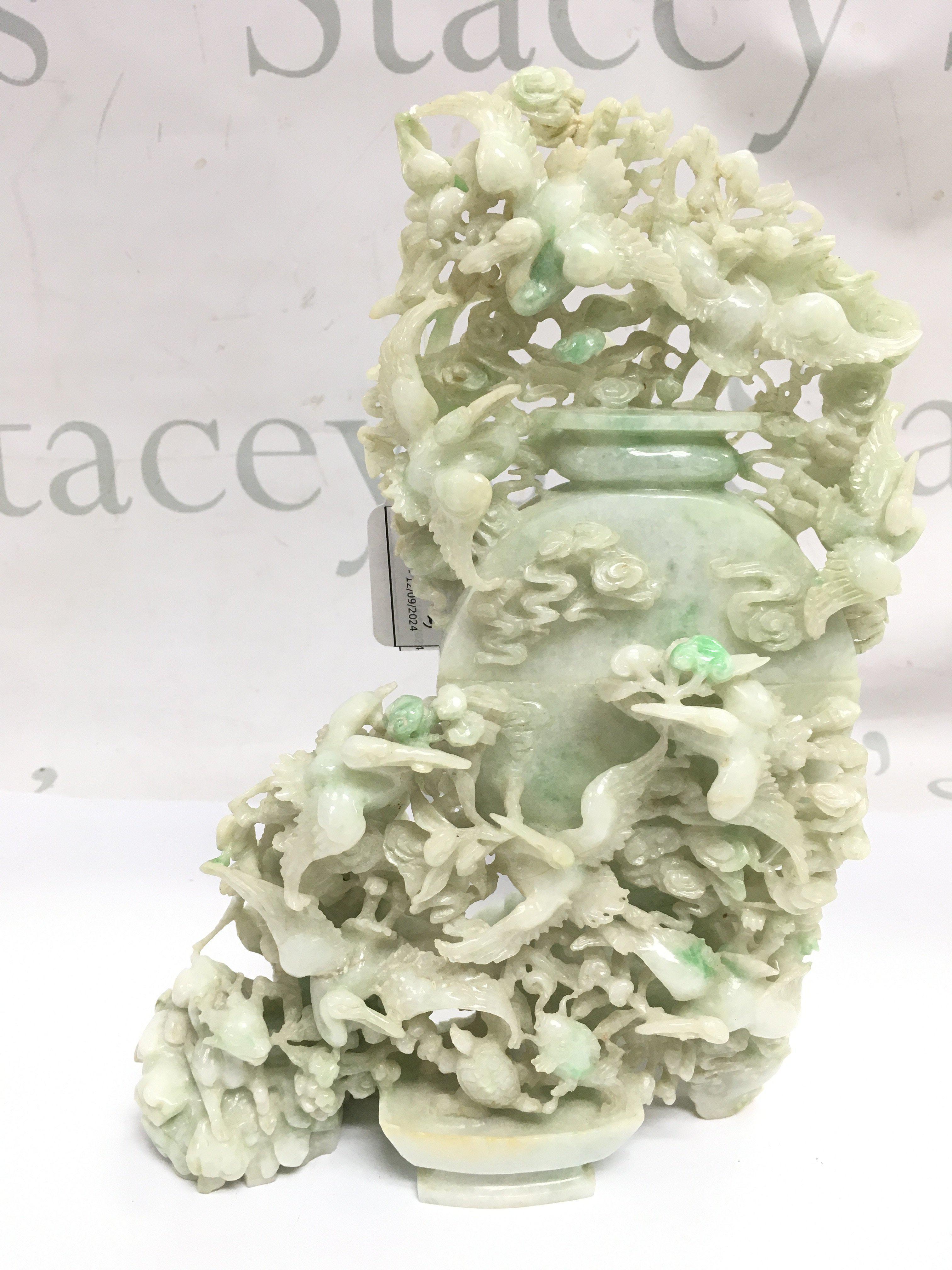 An impressive 20th century Apple Green dye Jade lidded pot surrounded by cranes and other animals, with box. Approximately 25cm tall 16cm wide .