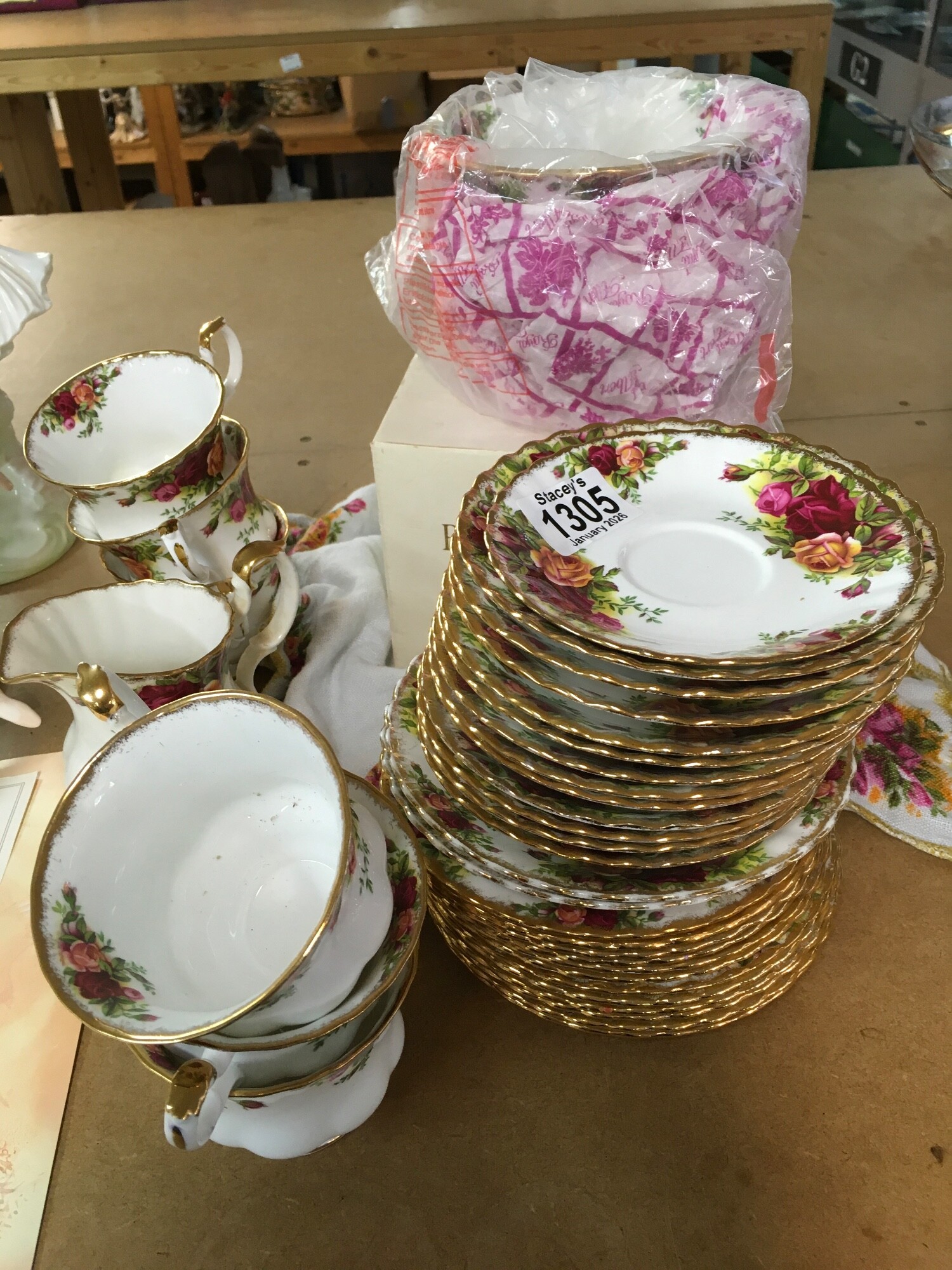 A Royal Albert Country Roses part tea set including a boxed vase, saucers, cups, milk jug etc