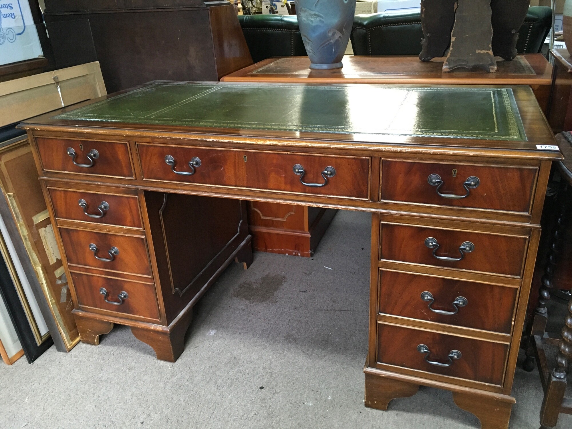 A Mahogany pedestal writing desk with a green leather insert. Dimensions 79cm tall, 136cm wide ,68cm long.
