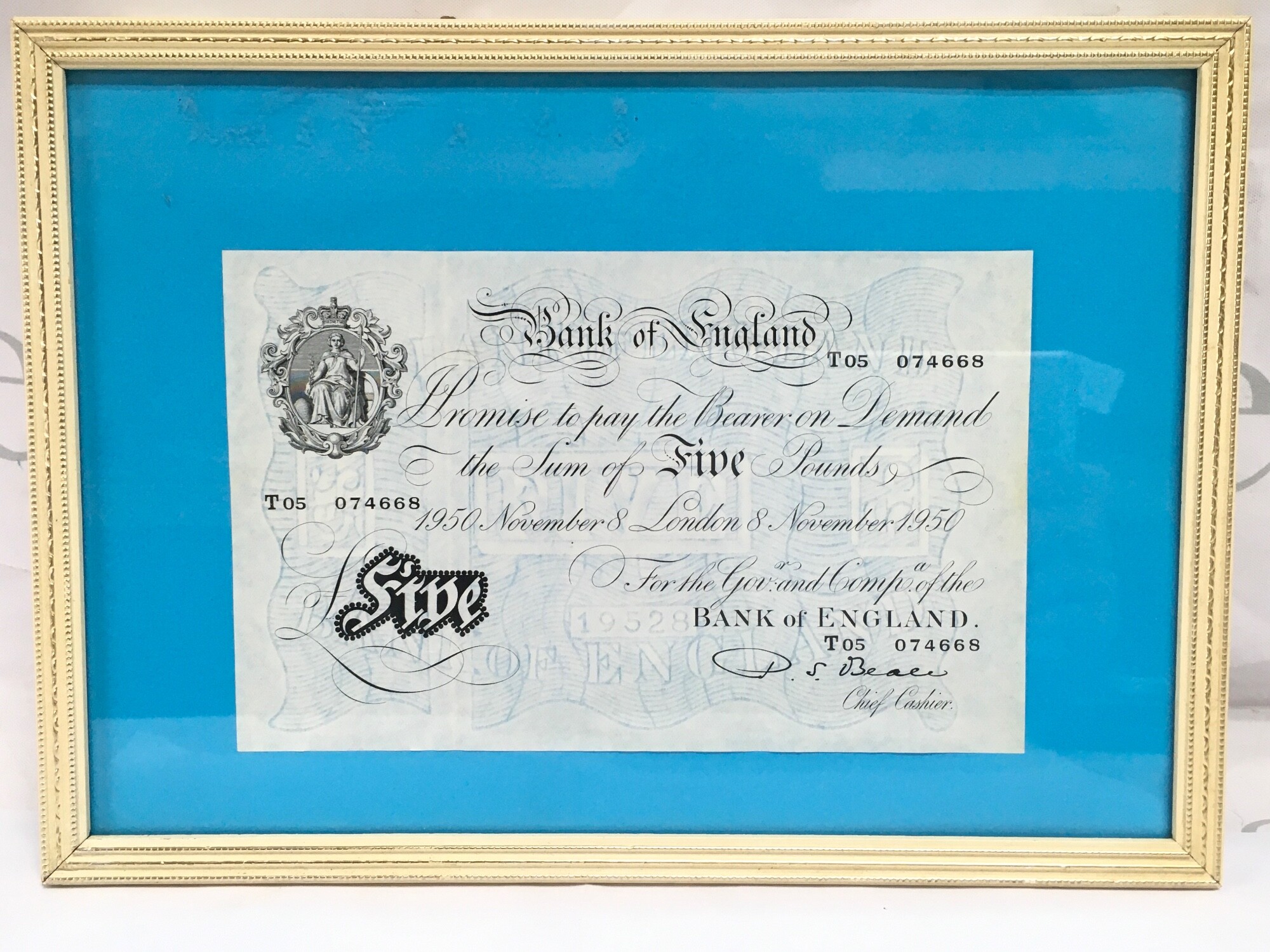A framed 1950 white £5 in near mint condition.