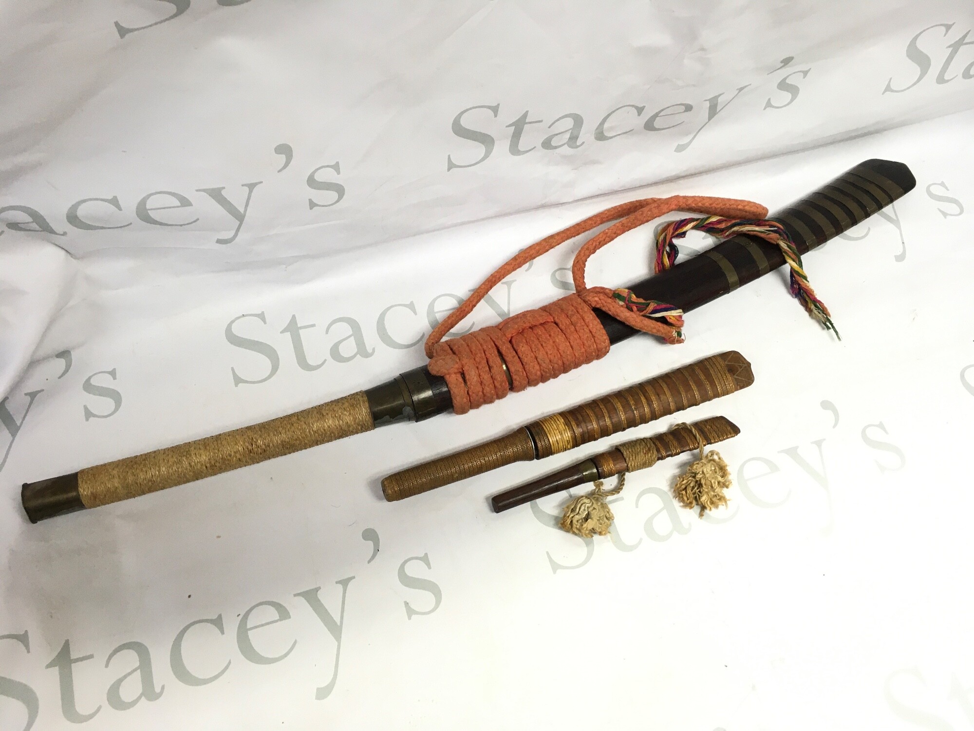 A Dha sword with two smaller knives, 19 to 74cm long approximately