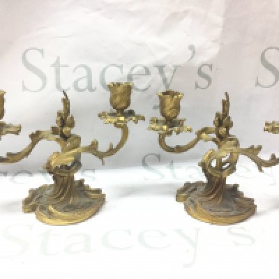 A pair of French ormoulo candelabras, approximately 15cm tall. 21cm wide.
