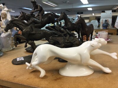 A collection of model horses including Racing together with Royal Doulton figure running wild .