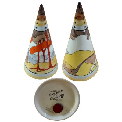 A Clarice Cliff Coral Firs sugar sifter. Slight damage to tip.