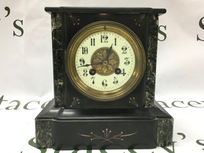 A black marble and slate mantle clock. 21cm tall 20cm wide.