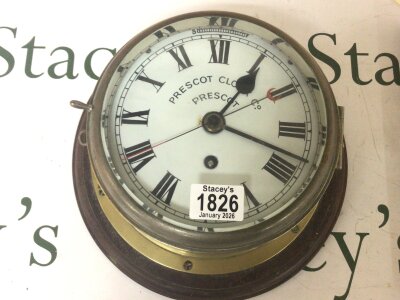 A Nice example of a Prescot ships clock in a brass case enamel dial single fusee movement seen working the dial with Prescot clock Co Prescot. Dial diamter 21cm