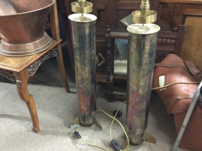 Vintage lamp bases made from artillery shell casings approximately 77cm tall.