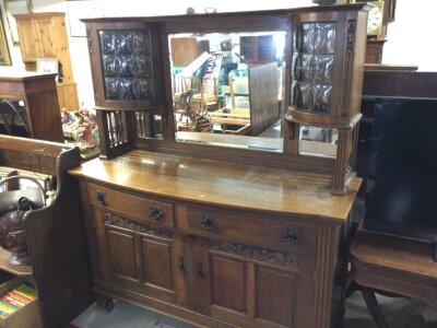 An oak sideboard with a mirrored back.
Approximately 52cm deep 152cm wide 175cm tall.