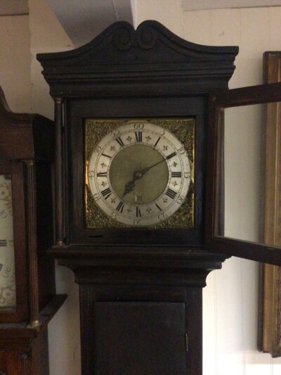 An Early 19th century longcase clock stained pine case with a brass dial and silver chapter ring 30h going maker W Barron London.