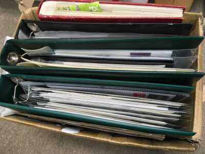 A box containing an album of first day covers, two albums of coin covers and album of mint Chanel island stamps and others