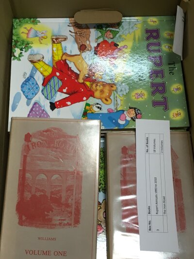 A box of Rupert annuals 1993 to 2010 and two volumes of the Iron Roads