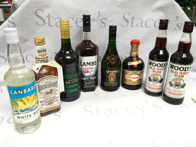 Eight bottles of alcohol including Old Huckleberry Whiskey, Lambs navy rum, Drambuie etc