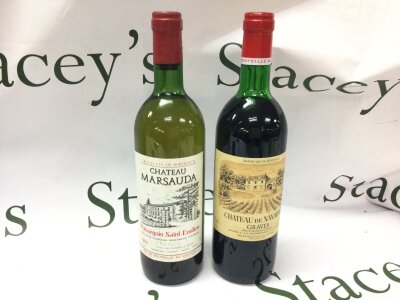 Two wines , A bottle of 1979 Chateau De Navarro Graves and a bottle of 1982 Chateau Marsauda Puisseguin Saint- Emilion.