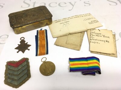 A collection of WW1 ephemera comprising medals, a Princess Mary tin etc.