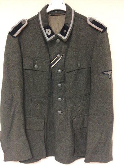 A Rare German Third Reich Totenkopt NCO Concentration Camp Guards Tunic with all insignia numbered on the Lining with some writing on the internal bandgate pocket