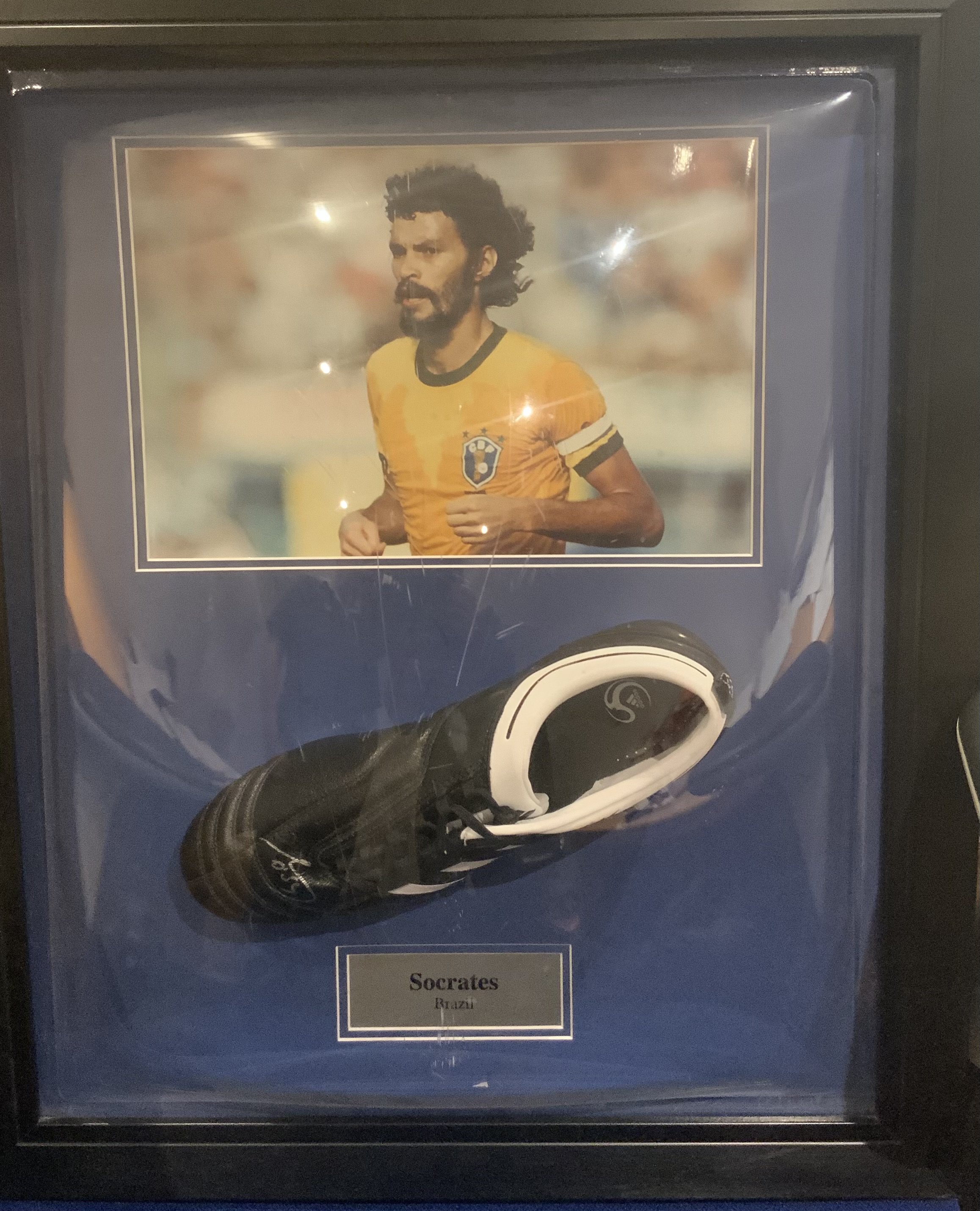 Socrates Brazil Signed Framed Football Boot: Adidas Adinova left boot with autograph and picture of player above. Framed has slight damage with Perspex having a few scratches.