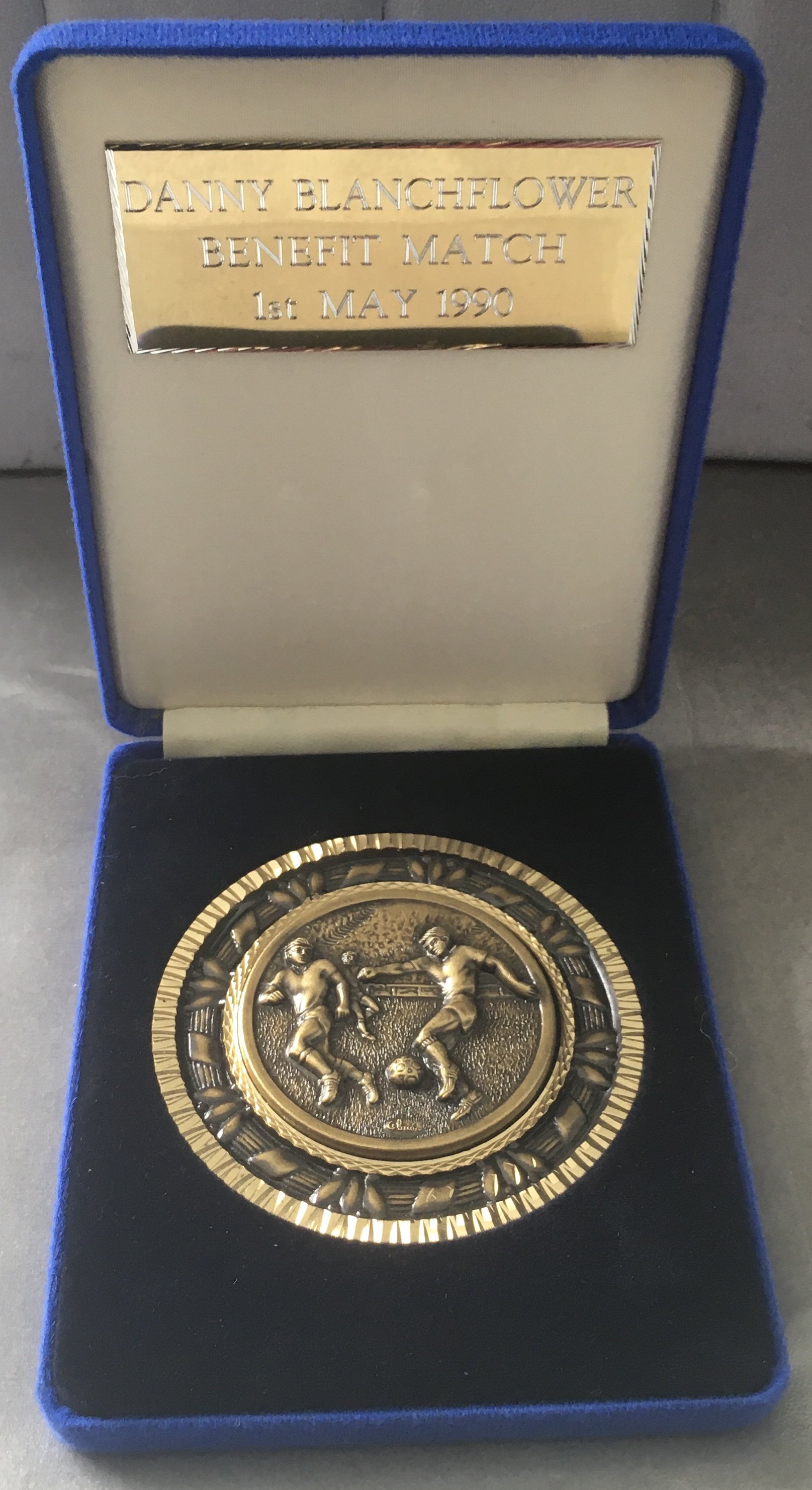 1990 Danny Blanchflower Tottenham Benefit Match Gift: Awarded to players and in this case Spurs secretary Peter Barnes for help in organising the match at White Hart Lane on 1 5 1990 in aid of Blanchflower who had just been diagnosed with Alzheimers and this helped pay for the remaining 3 years of his life. Excellent condition large medal in a box with match details on a plaque.
