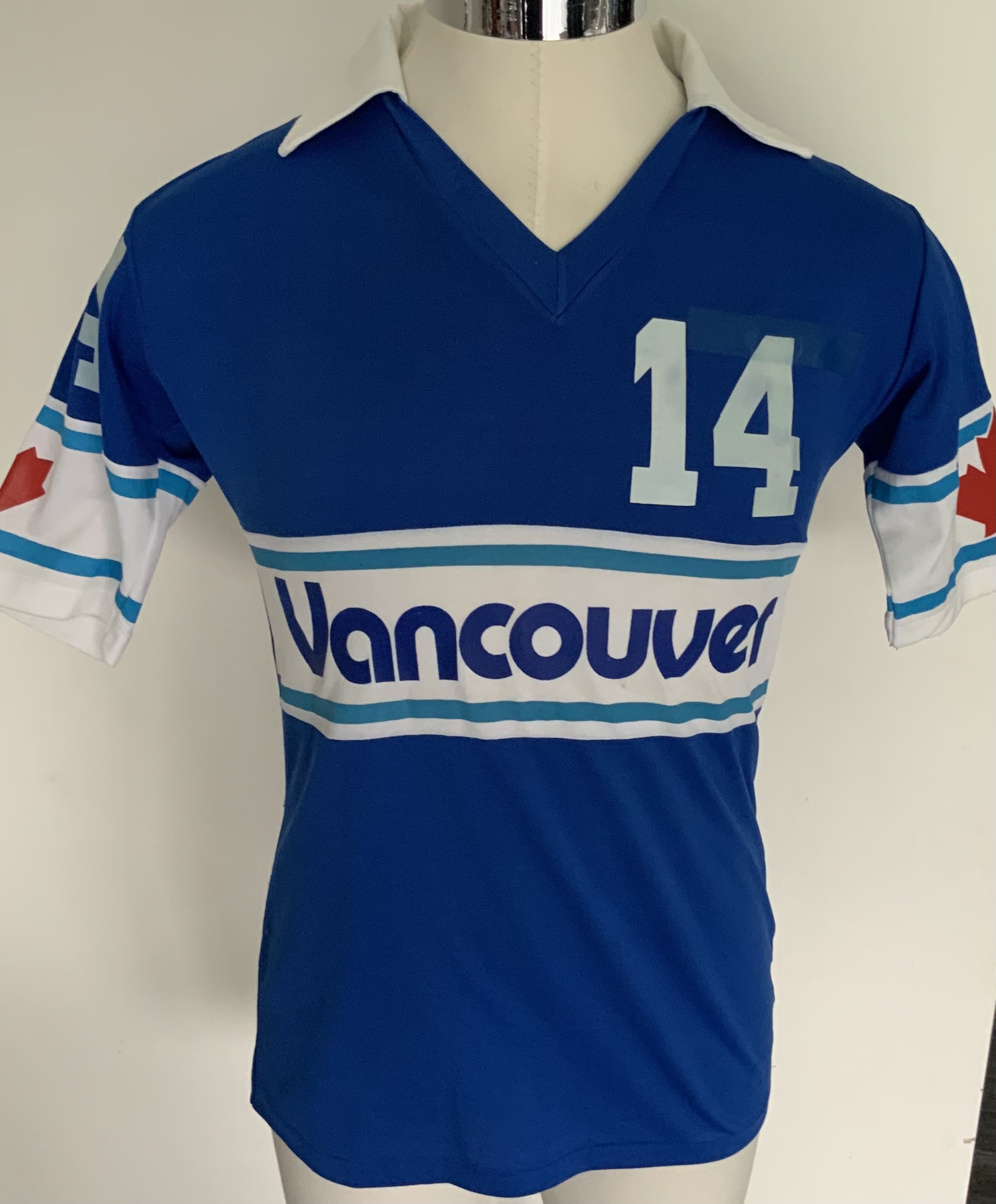Vancouver Whitecaps 1981 Match Worn Football Shirt: Excellent condition very rare away shirt made by Penmans. Number 14 to front, rear and sleeves. Both sleeves have the Canadian flag. Medium size attractive shirt has Taylor to rear. The NASL dissolved in 1984 with many participating teams going the same way. COA from Alan Taylor.