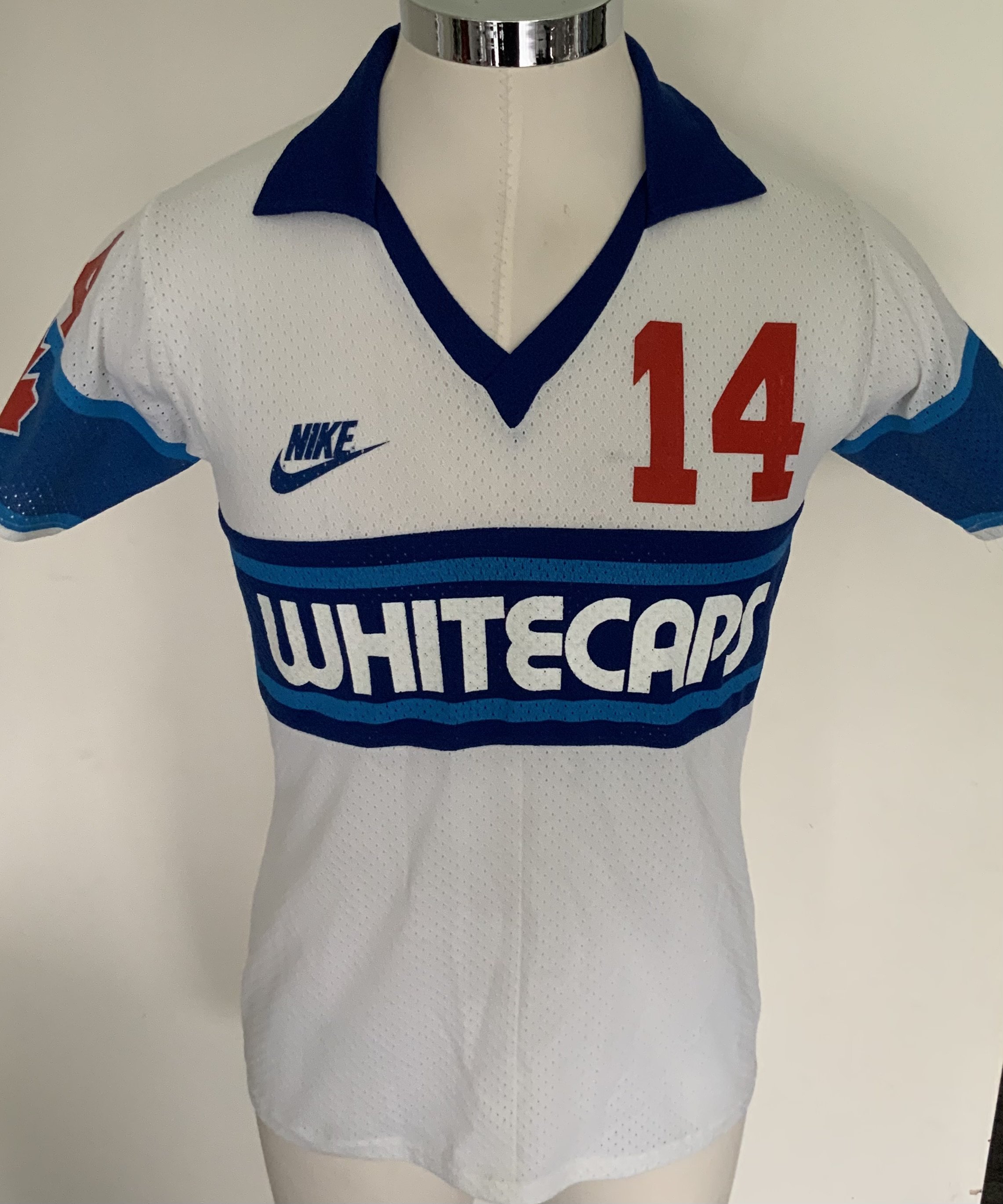 Vancouver Whitecaps 1982 Match Worn Football Shirt: Excellent condition very rare home airtek style shirt made by Nike. Number 14 to front, rear and sleeves. Both sleeves have the Canadian flag. Medium size attractive shirt has Taylor to rear. The NASL dissolved in 1984 with many participating teams going the same way. COA from Alan Taylor.