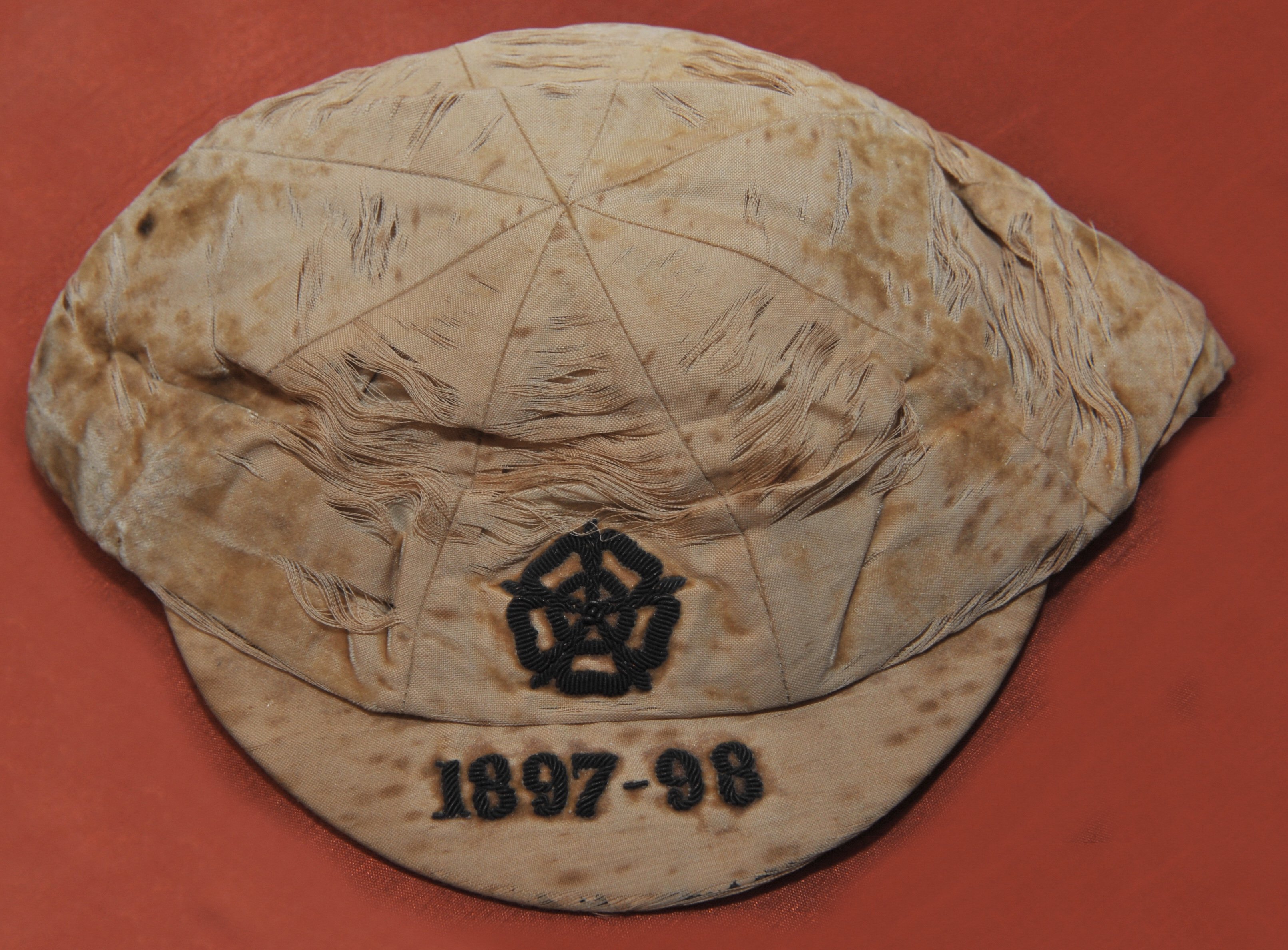 Billy Williams West Brom 1897 - 1898 England Football Cap: Full International match which ended Ireland 2 England 3 played in Belfast which was Billys 2nd full cap. Wear and discolouration to cap that was made by Foster + Co. Peak is embroidered 1897-98.