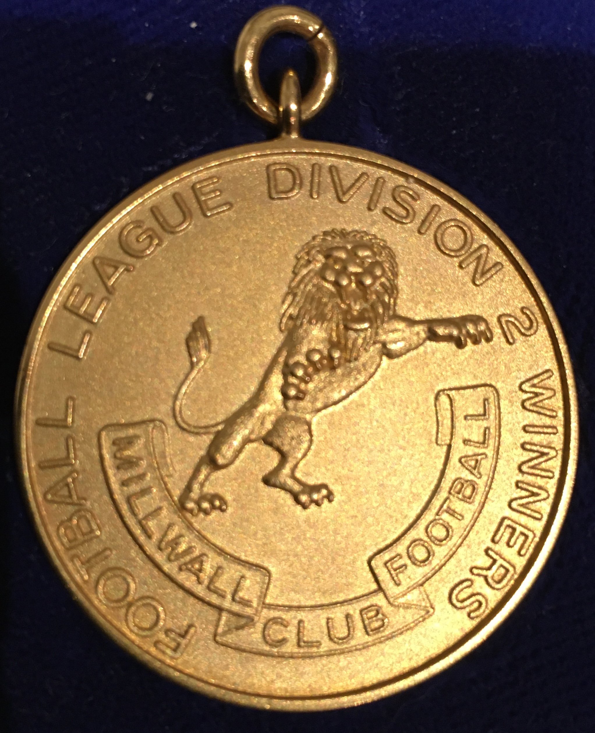 Millwall 87/88 Football League Division Two Winners Medal: Superb 9ct gold medal awarded to Millwall coach Roger Cross. Different and better than the one issued by the Football League to players. This medal has Millwall Football Club and lion circled by the words Football League Division 2 Winners with the reverse having the words Season 1987-88 and gold hallmark. In official Football League box from usual maker Vaughtons.