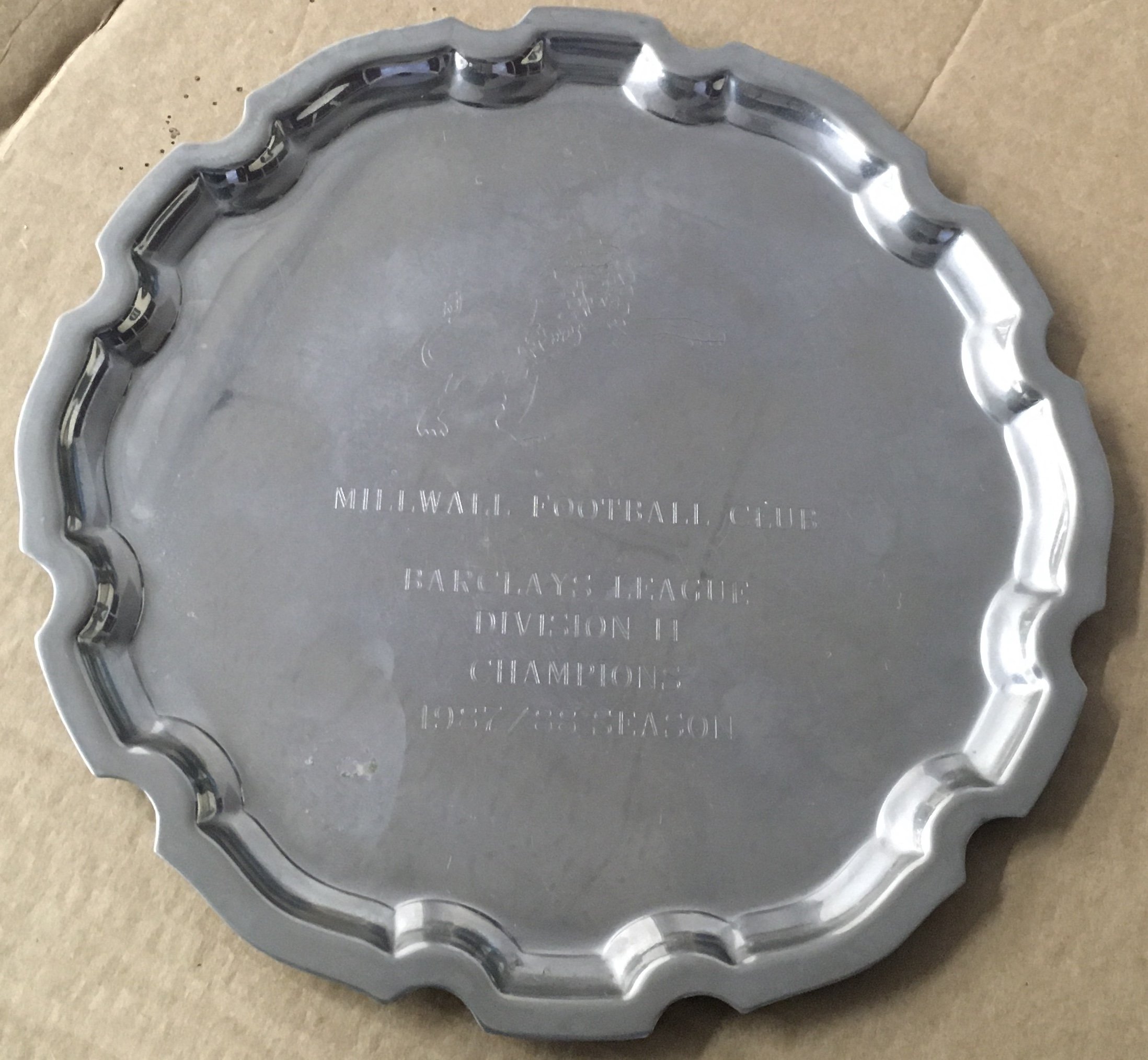 Millwall 87/88 Football League Division Two Winners Salver: 8 inch silver coloured salver awarded to Millwall coach Roger Cross. Beneath the lion are the words Millwall Football Club Barclays League Division 2 Champions 1987/88 Season. Not commercially available.