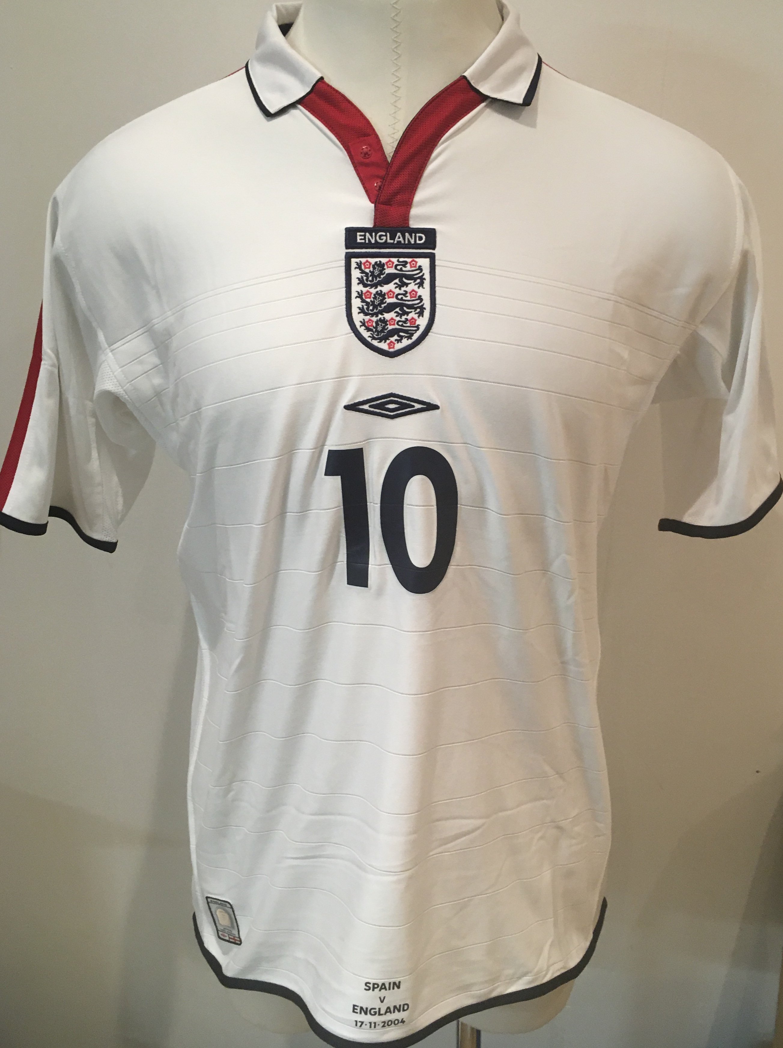 2004 Michael Owen Match Worn England Football Shirt: White short sleeve large shirt with number 10 to front and back with Owen to rear. Very bottom to front middle reads Spain v England 17 11 2004. Obtained by Peter Barnes the Tottenham and West Ham club secretary who worked also for England.
