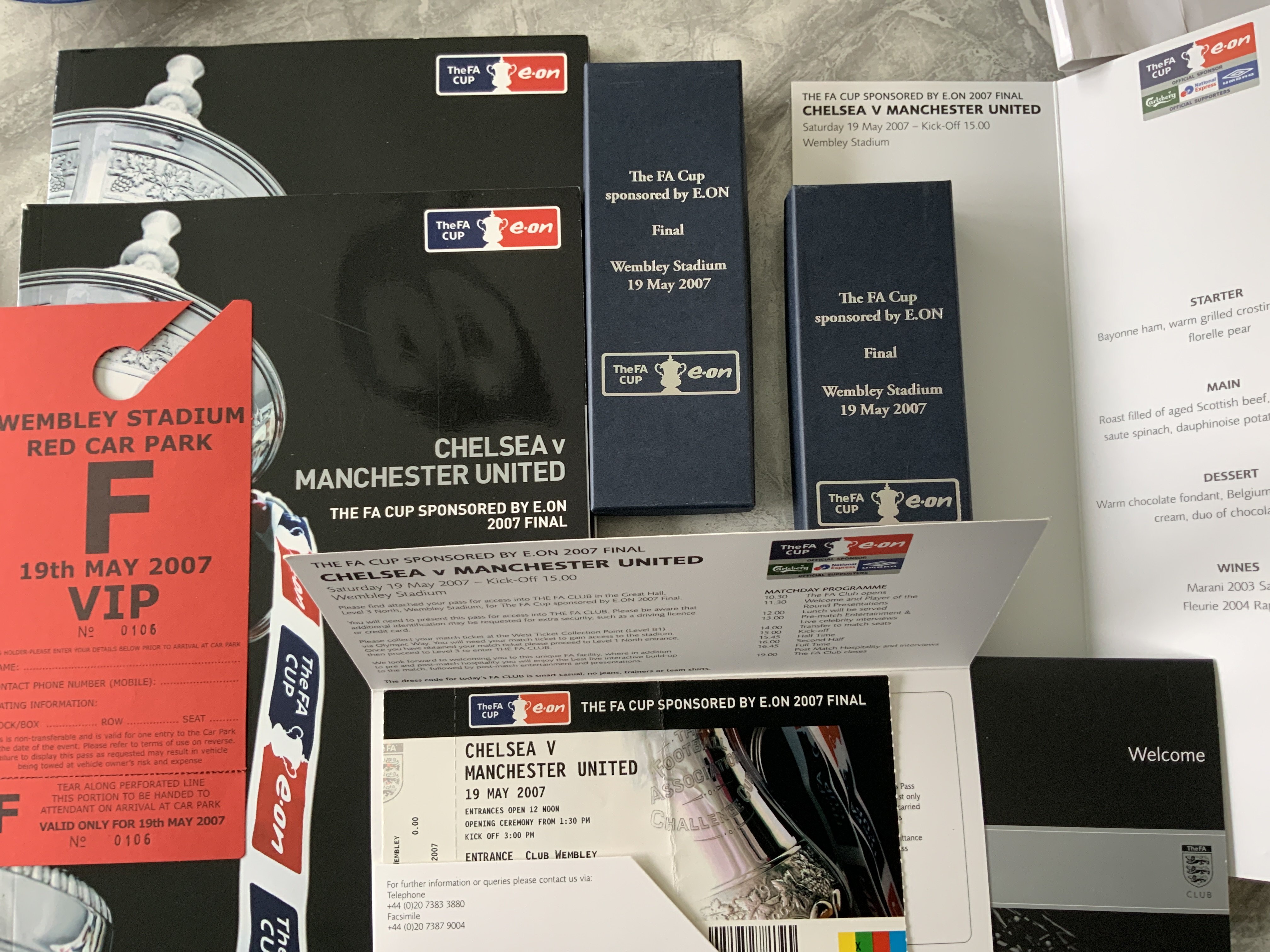 2007 FA Cup Final Football Memorabilia: First FA Cup final back at Wembley between Chelsea and Manchester United. Previous winners at the old ground were invited by the FA to celebrate this occasion. There are 2 programmes lanyards boxed pens and tickets, Menu, VIP parking, letters, badges etc. C/W 2006 programme and ticket and a few other final programmes. Former property of guest Alan Taylor.