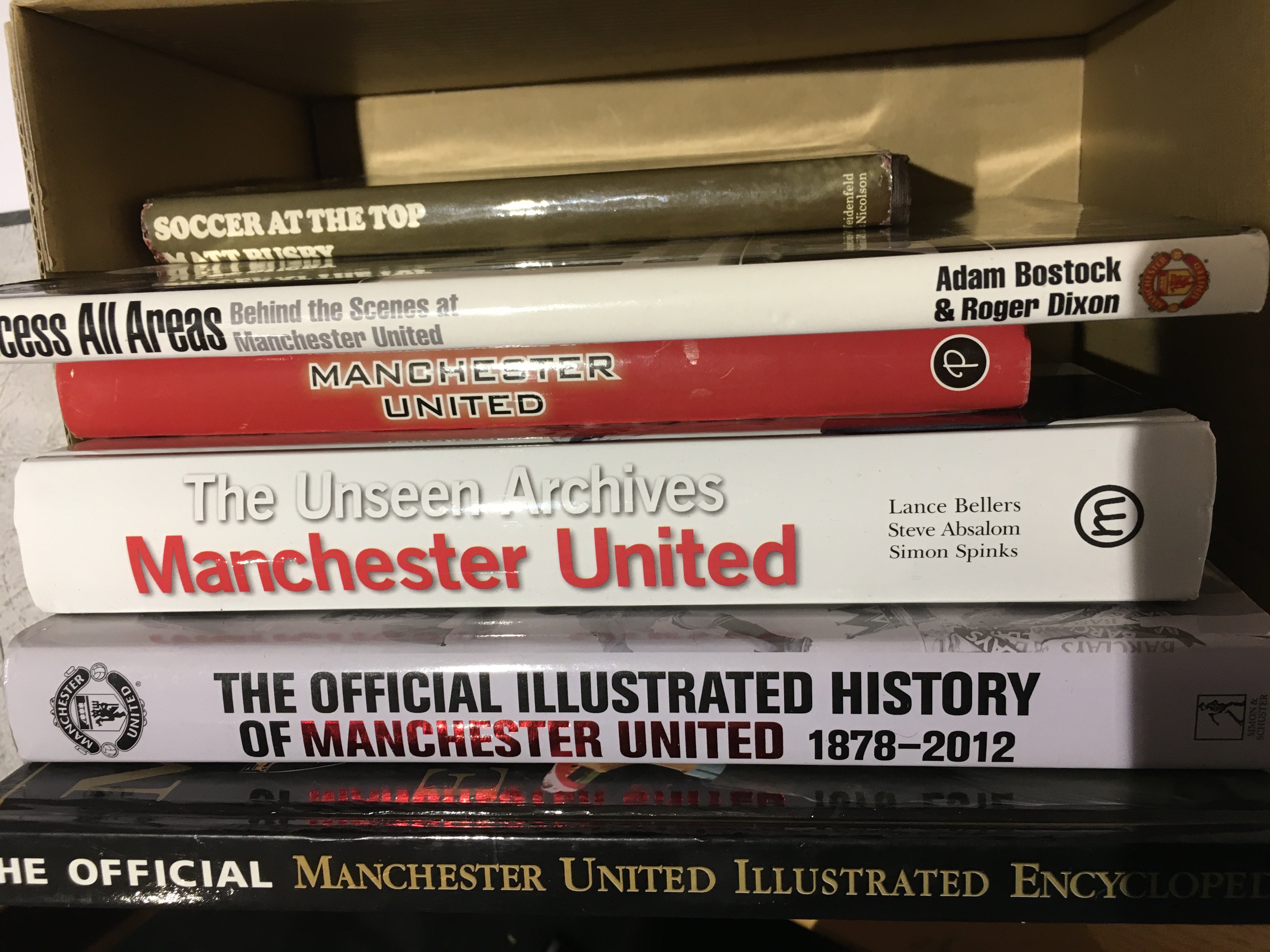 Manchester United Football Books: Excellent condition with no reserve to include Sir Bobby Charlton, Illustrated Encyclopaedia, Illustrated History, Unseen Archives, Access All Areas, Photographic History and Matt Busby autobiography with a stuck in picture signed by Denis Law. (7)
