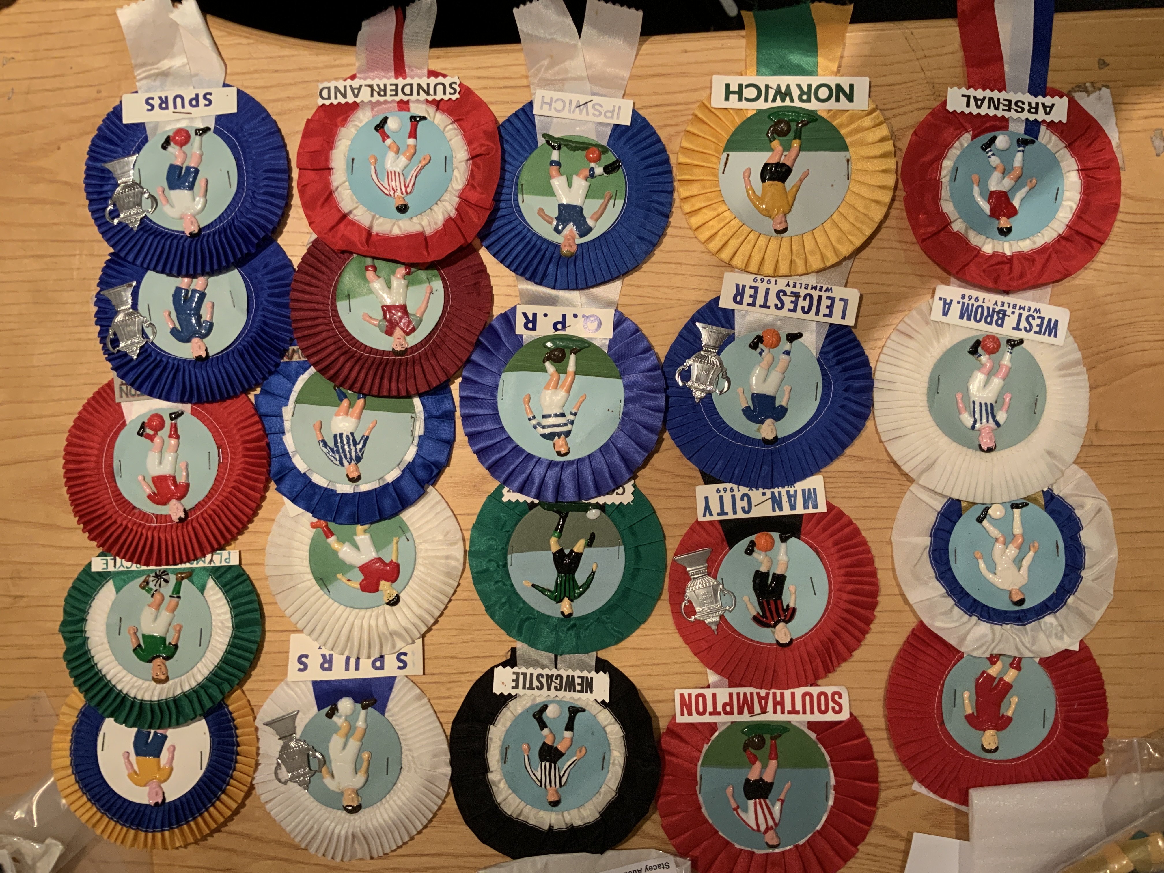 Football Club Rosettes: Stunning with plastic footballer in club kit to centre. Includes Tottenham Arsenal West Ham Leicester Man City and West Brom. Excellent. (22)