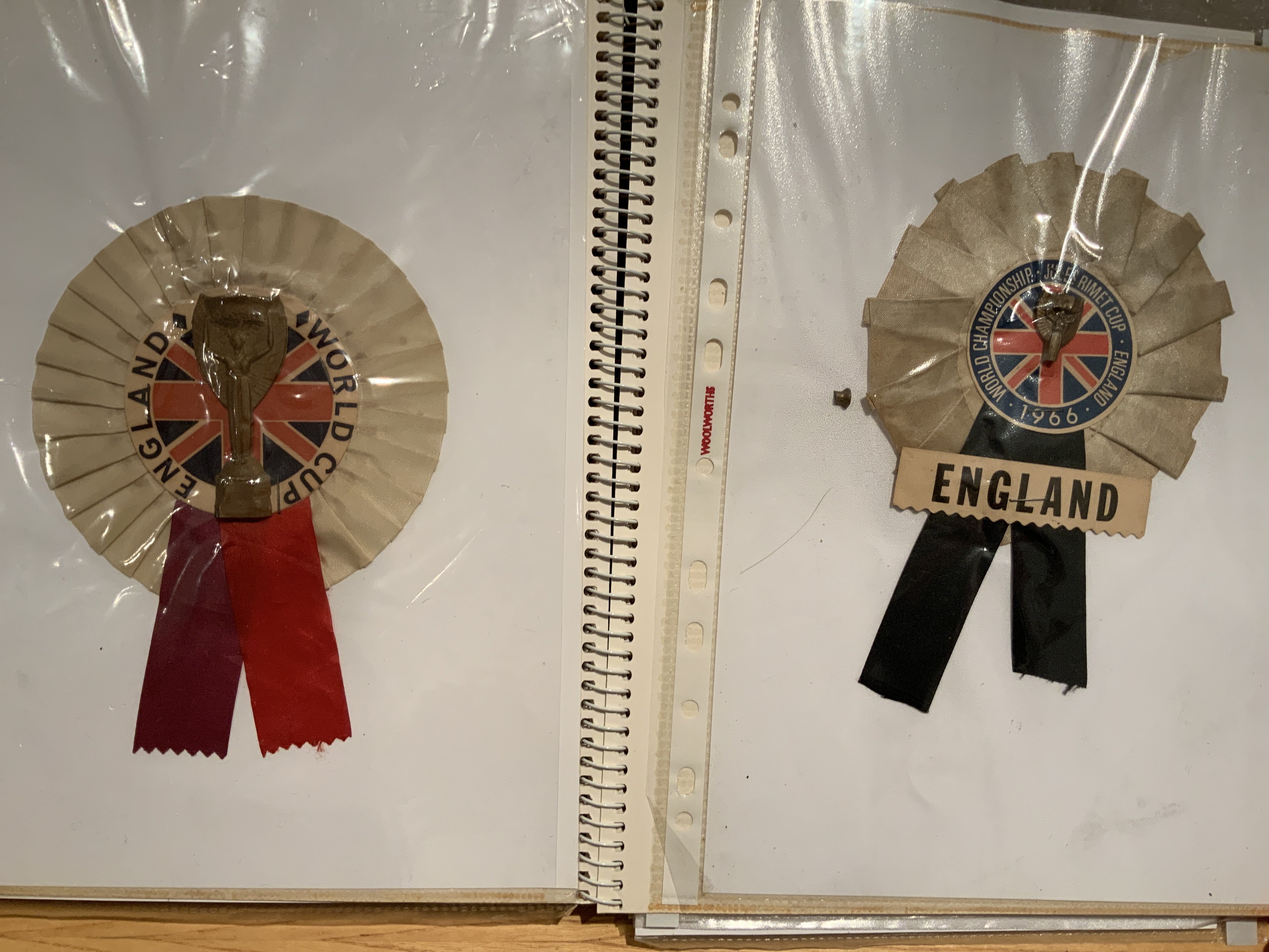 1966 England World Cup Rosette Collection: 12 different rosettes with many featuring the Jules Rimet trophy or World Cup Willie. Housed nicely in collectors folder. (12)