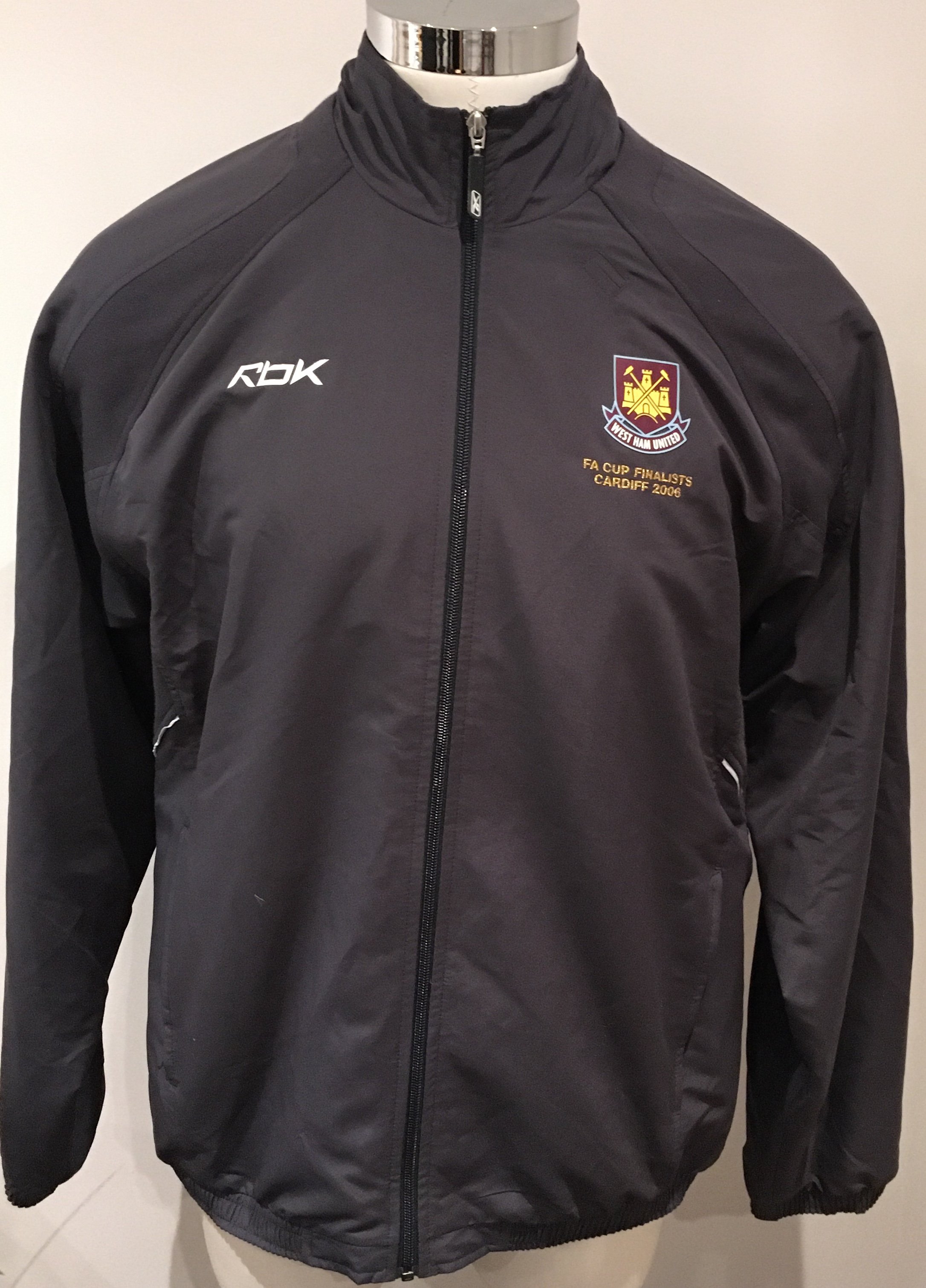 West Ham 2006 FA Cup Final Football Tracksuit: Grey Reebok tracksuit in size XL worn by West Ham coach Roger Cross. Top and bottoms have the old West Ham crest and top has the words FA Cup Finalists Cardiff 2006. Excellent condition and never commercially available.