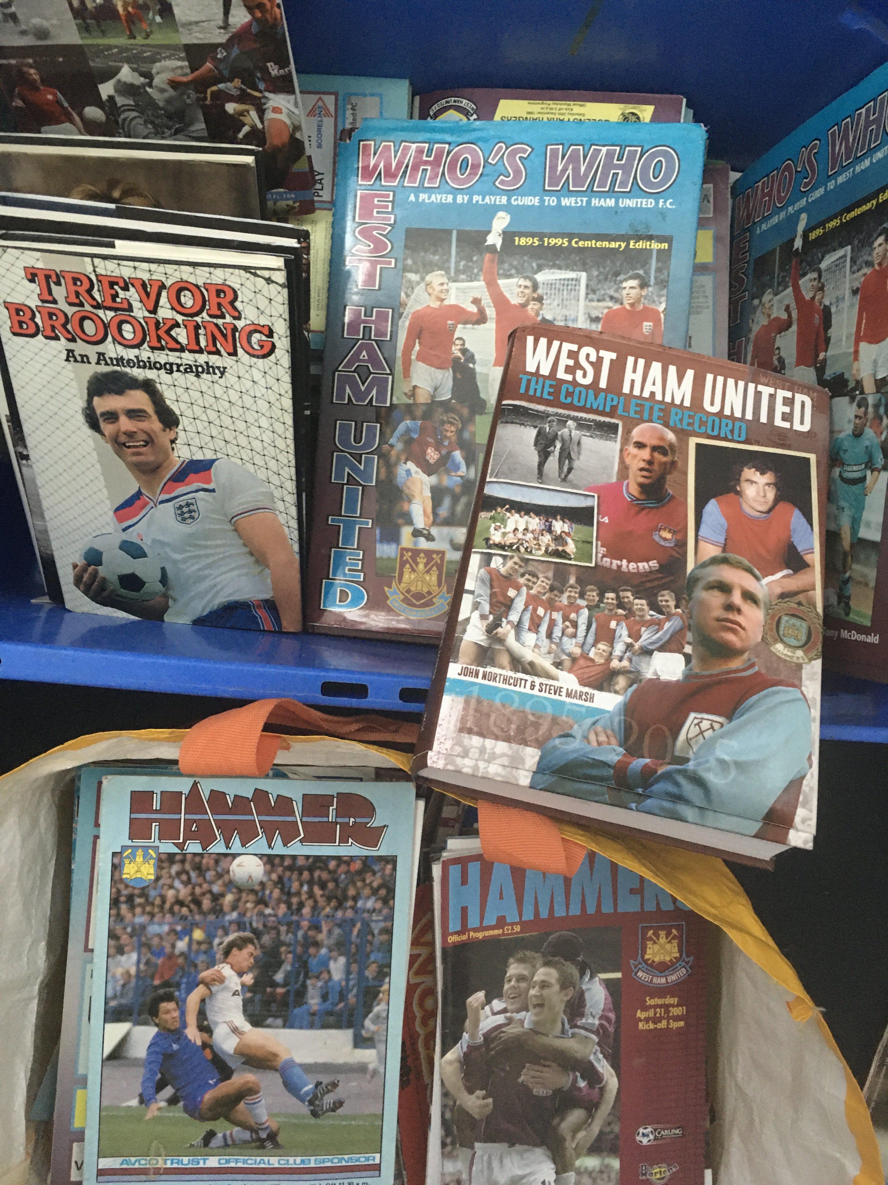 West Ham Football Memorabilia Box: 1981 menu signed by 7 including Ferguson Pearson Brooking and Parkes, 1995 calendar signed by 7, 1981 calendar, undedicated books signed by McAvennie, Hurst and a few dedicated books, Hursts new book unsigned and a large quantity of quite modern programmes, (2 boxes)