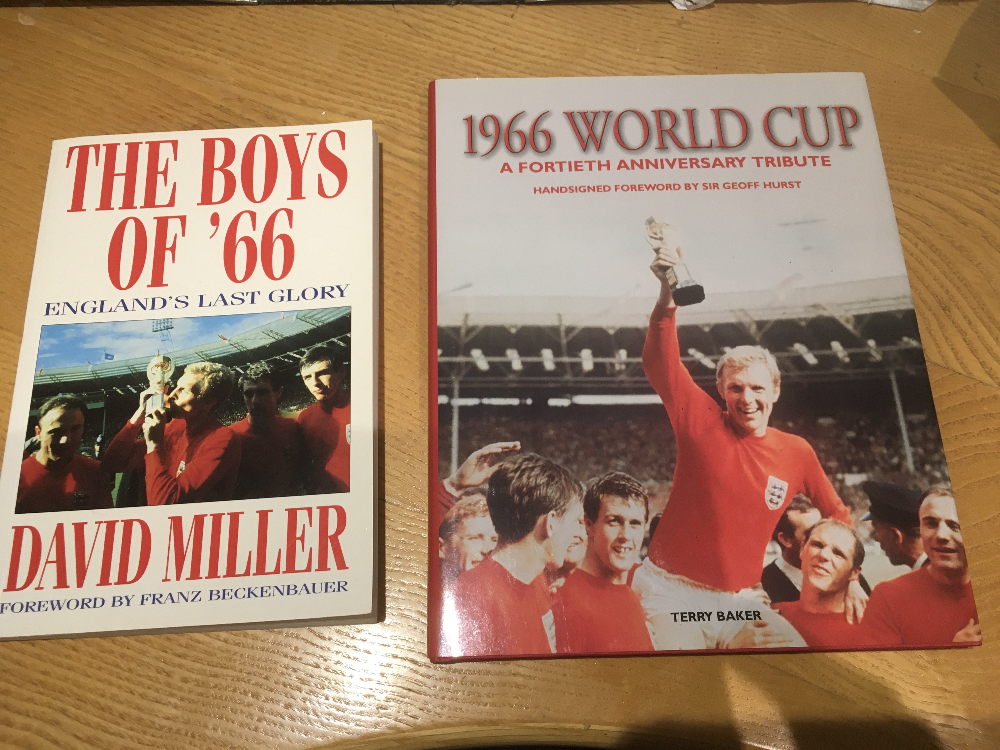 England 1966 World Cup Signed Football Books: Boys Of 66 soft cover by David Miller signed by Gordon Banks Martin Peters Geoff Hurst and Jimmy Greaves. Hardback 40th anniversary of the 1966 World Cup by Terry Baker with autograph of Geoff Hurst. (2)