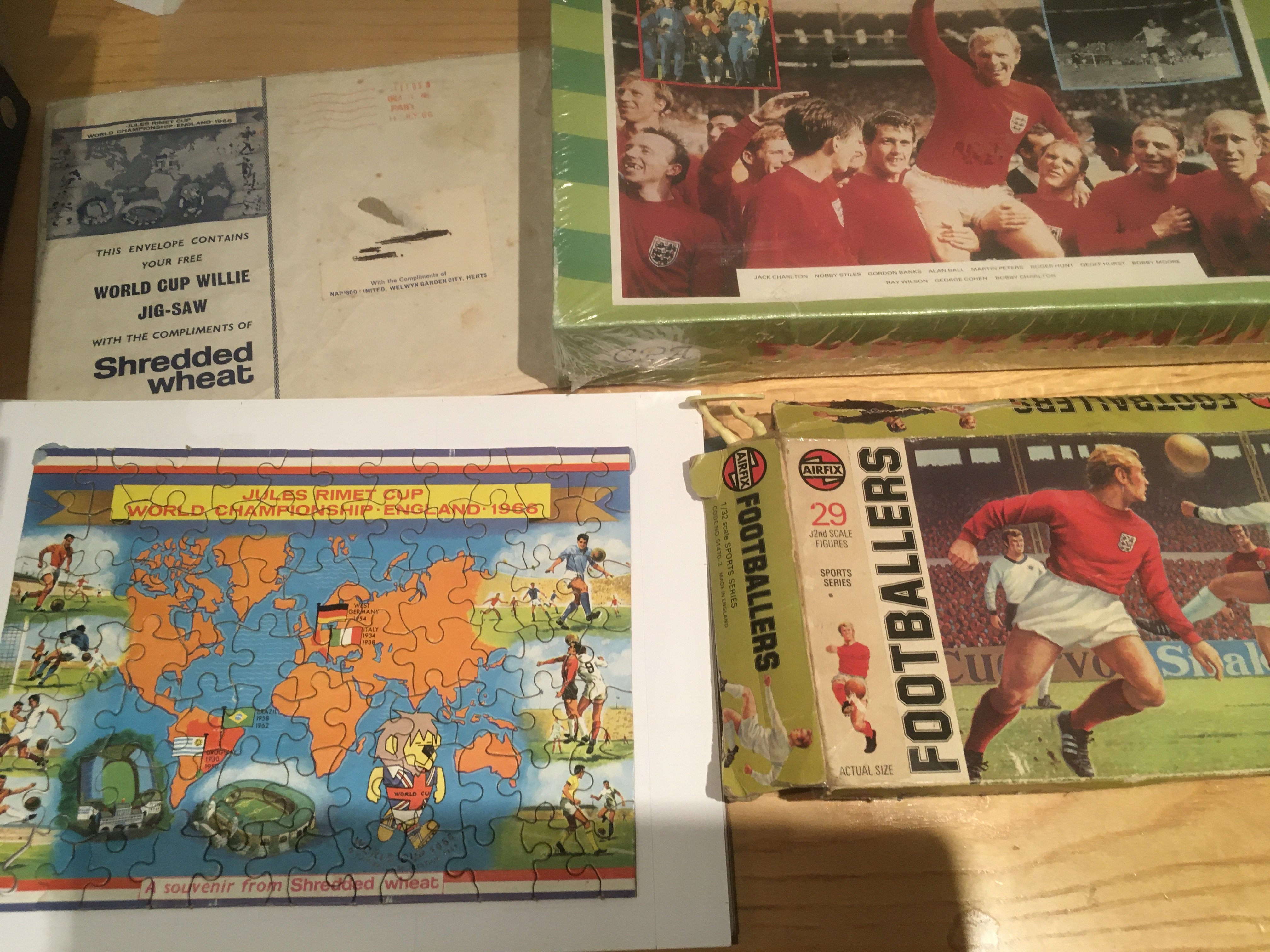 1966 World Cup Football Memorabilia: Shredded Wheat World Cup Willie complete puzzle with original envelope. 1966 sealed boxed puzzle. Airfix Footballers with damaged box and unchecked contents. (3)