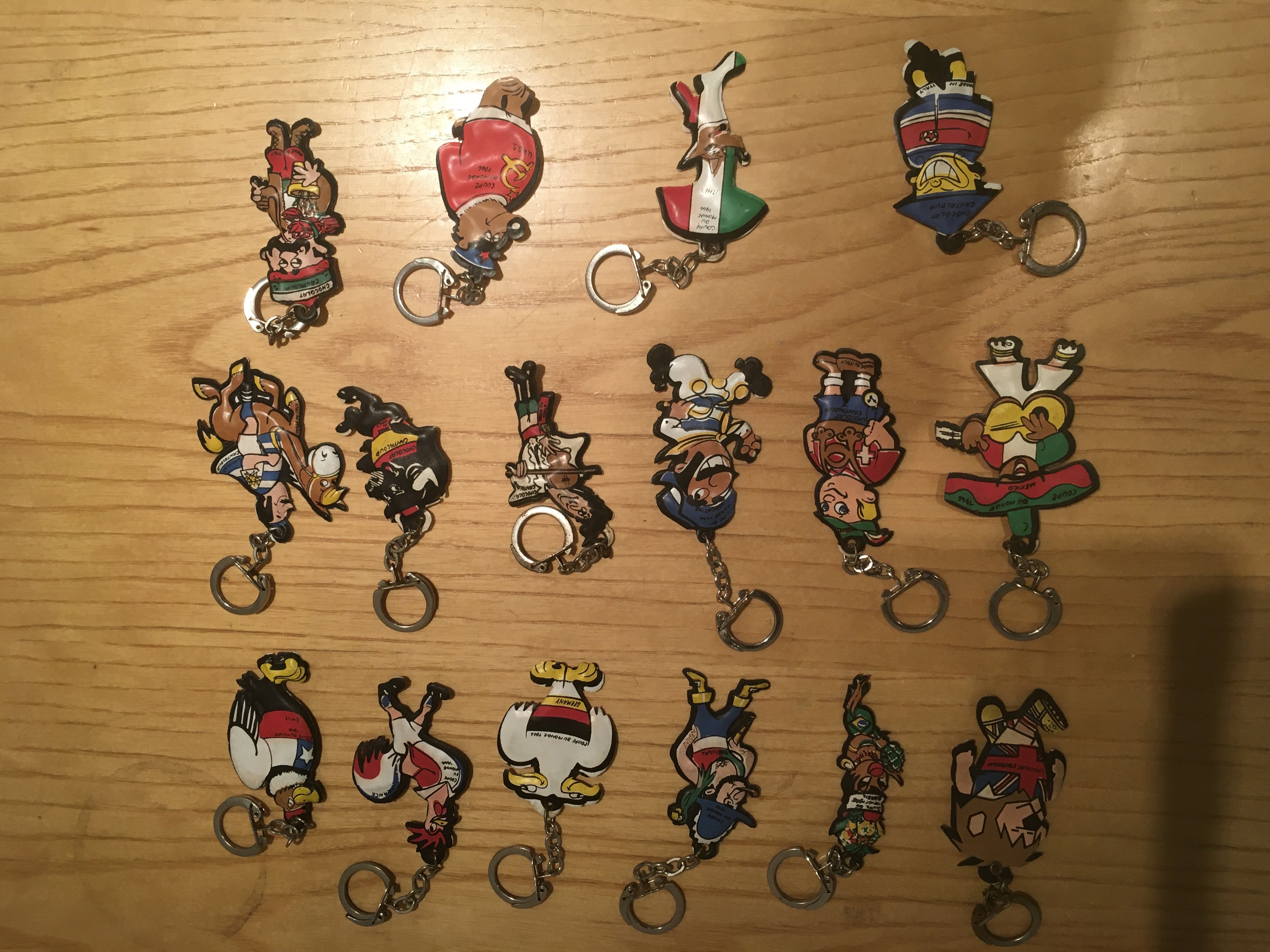 1966 World Cup Finals Teams Football Key Rings: Very rare full set of 16 countries made in Europe of stereotypical caricatures on quality padded key rings. England is represented by World a cup Willie. Excellent original condition for nearly 60 years old. (16)