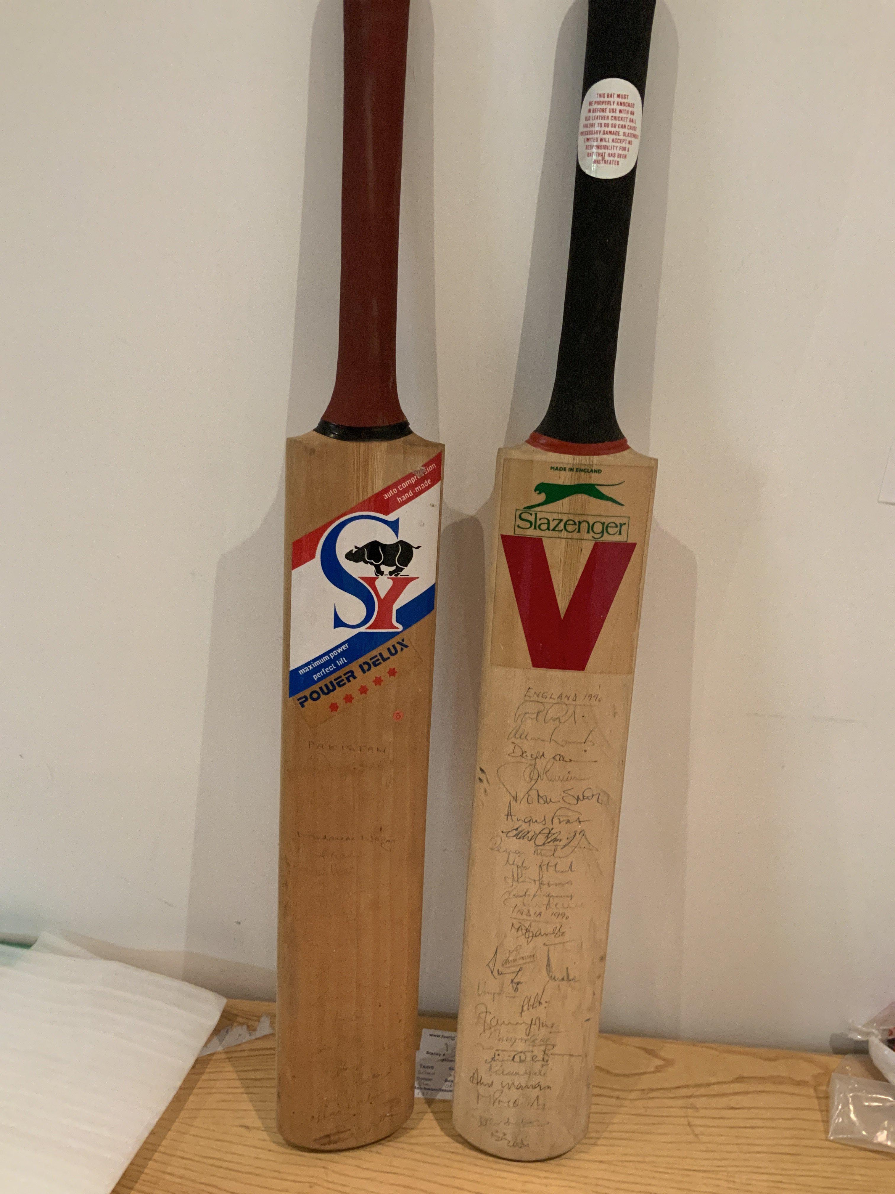 Cricket Memorabilia Box: 2 signed bats including England and India on one bat plus 1990 Pakistan which is fading. Cricket books, Annuals, Postcards, 1956 Autographs, Middlesex signed player postcards and more. Instructions to sell. (2 boxes)