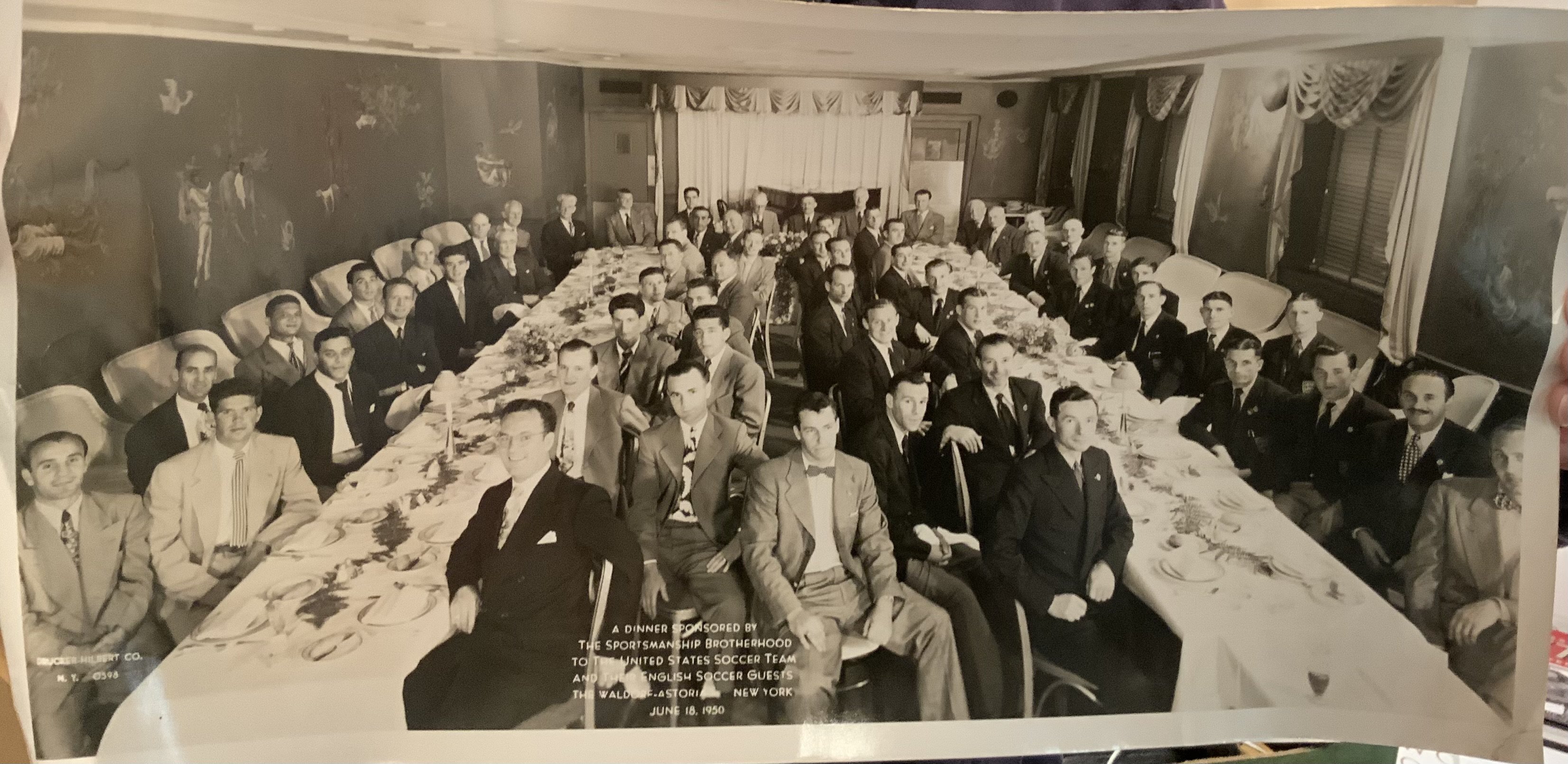 1950 Manchester United + England FA X1 USA Tour Football Photo: Original photo of the Man Utd and England team in New York on June 18 1950 at a dinner hosted by the USA national team. 20 x 10 inches on the old card paper used in the day but no press stamp.