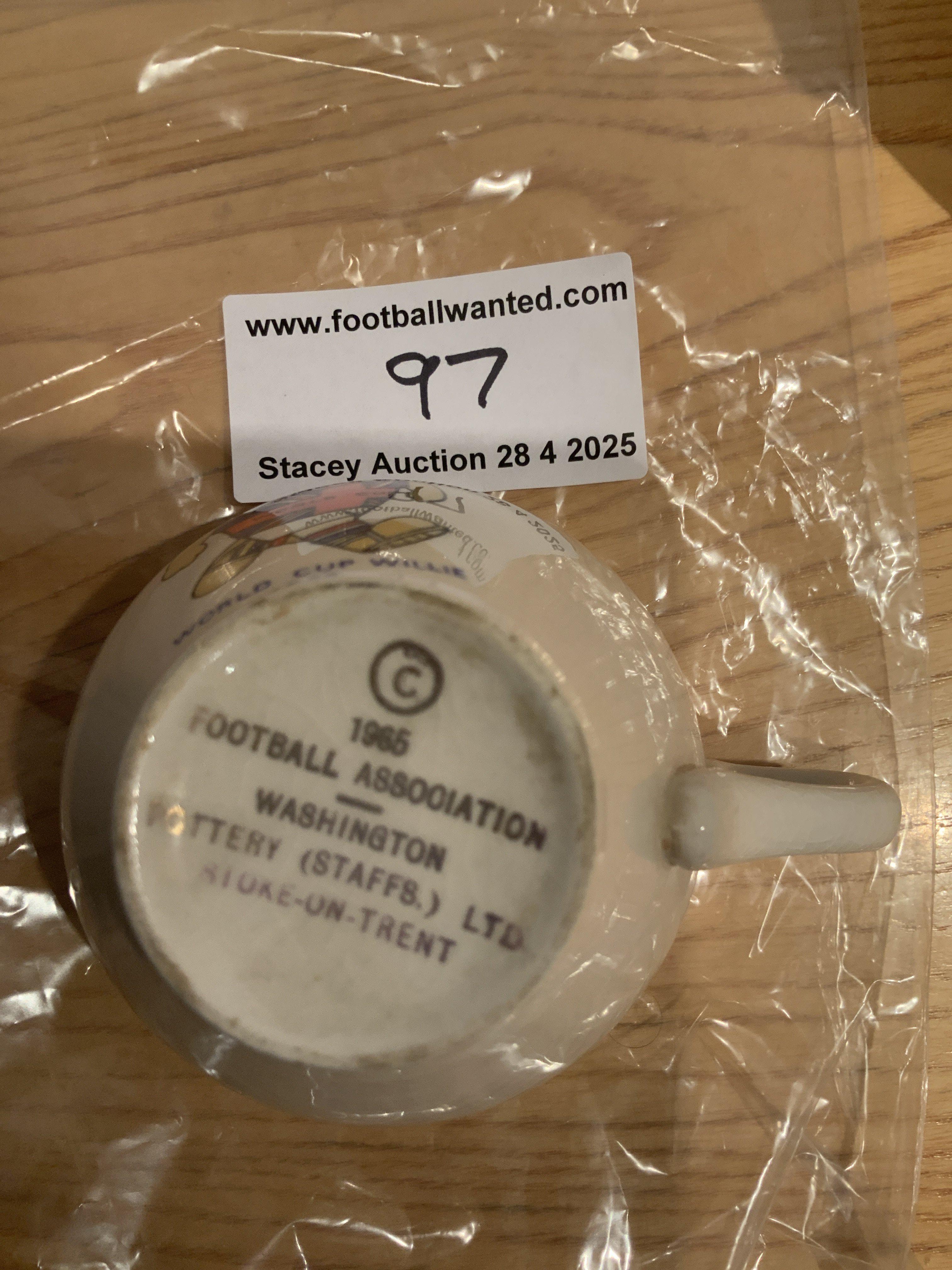 1966 World Cup Willie Tea Cup: Stunning condition and never used with Willie looking very bright above the words World Cup Willie 1966. Underneath has Football Association Washington Pottery of Stoke makers mark.