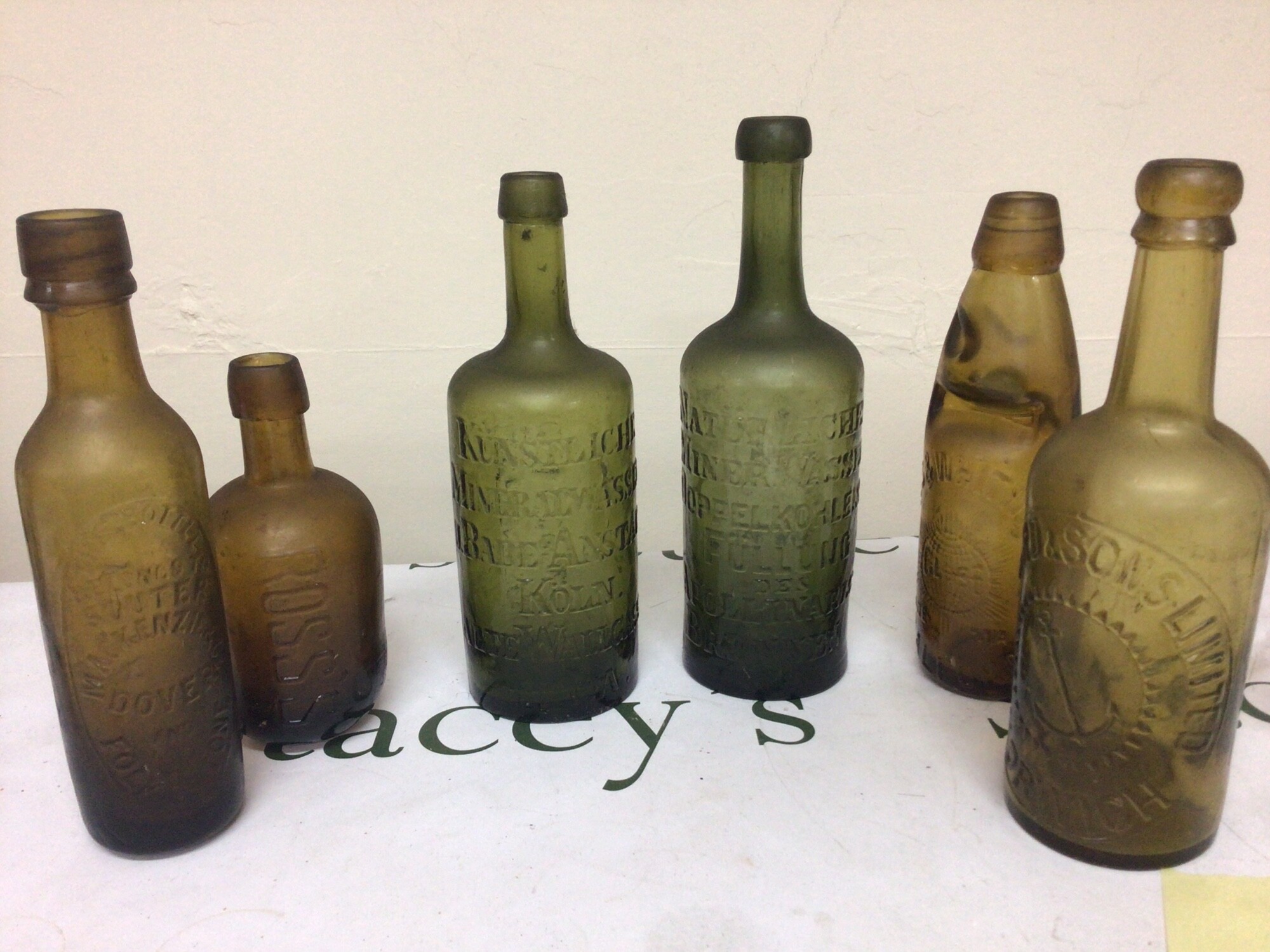 Two German 19th century 1860-70 Mineral water chemist green glass bottles a Bullard & Sons bottle Norwich Groves & Whitnall glass Codd bottle a small Ross’s of Belfast bottle and crystal trade mark bottle Dover & Folkestone.  All in good condition no obvious faults. No Reserve.