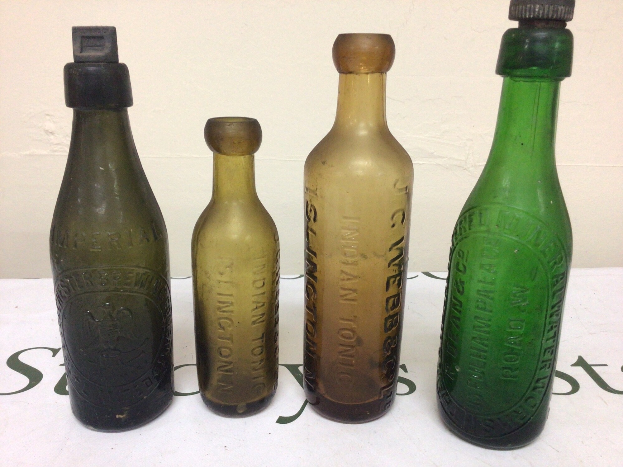 Four Antique green and brown glass bottles Indian tonic Mineral water and the Colchester Brewing Company. No obvious damage NO Reserve (4)
