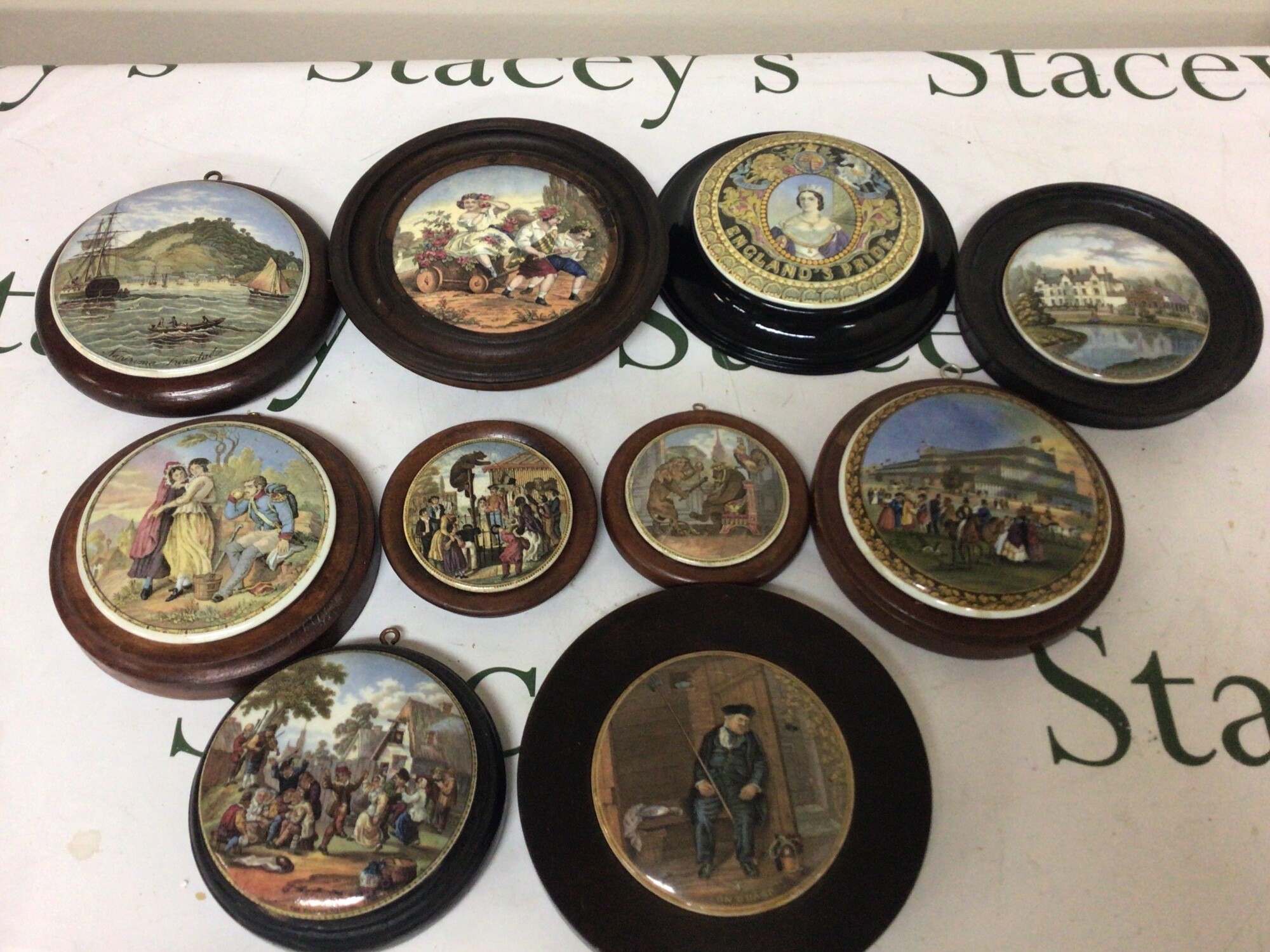 A collection of ten illustrated Victorian pot lids including bear batting 1851 Crystal Palace a rare view of Napirima The village wedding and others NO RESERVE. (10)