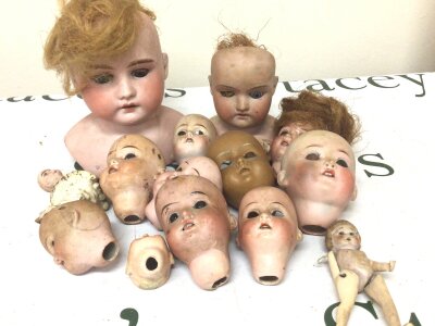 A collection of bisque Victorian dolls heads. NO RESERVE.