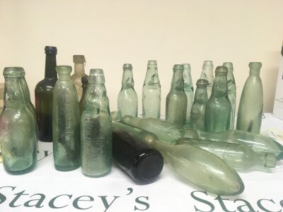 A collection of Victorian and later glass bottles Cod Bottles and others most with moulded trade and makers labels and a very early 19th century wine bottle and many others.