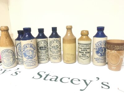A collection of Victorian stoneware bottles Rock Blue Wormwood Scrubs and others including a Lambeth Doulton Victorian commemorative beaker .